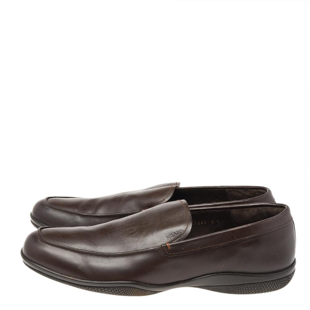 Let comfort and classic style be yours with these designer loafers from Prada. Crafted in brown leather, the high-quality shoes have the perfect construction to take you through the day with utmost ease.

