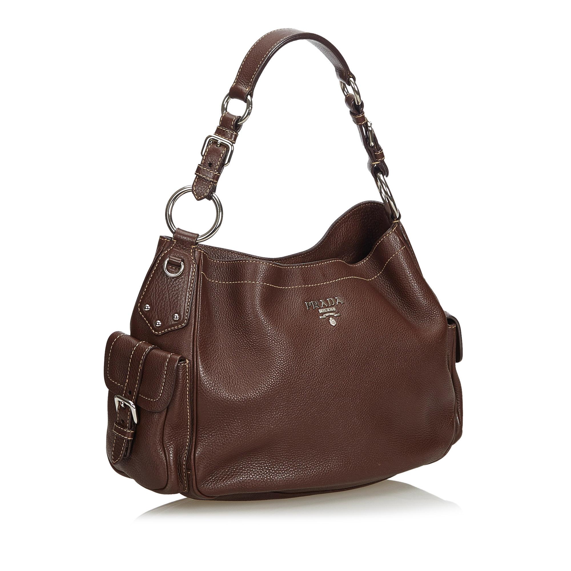 This hobo bag features a leather body, exterior flap pockets, flat leather strap, an open top with a magnetic snap button closure, and an interior zip pocket. It carries as B+ condition rating.

Inclusions: 
This item does not come with