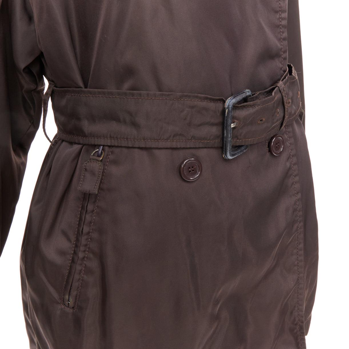 PRADA brown low sheen nylon double breasted short trench coat
Reference: CNPG/A00108
Brand: Prada
Designer: Miuccia Prada
Material: Nylon
Color: Brown
Pattern: Solid
Closure: Belt
Lining: Brown Fabric
Made in: Italy

CONDITION:
Condition: Fair, this