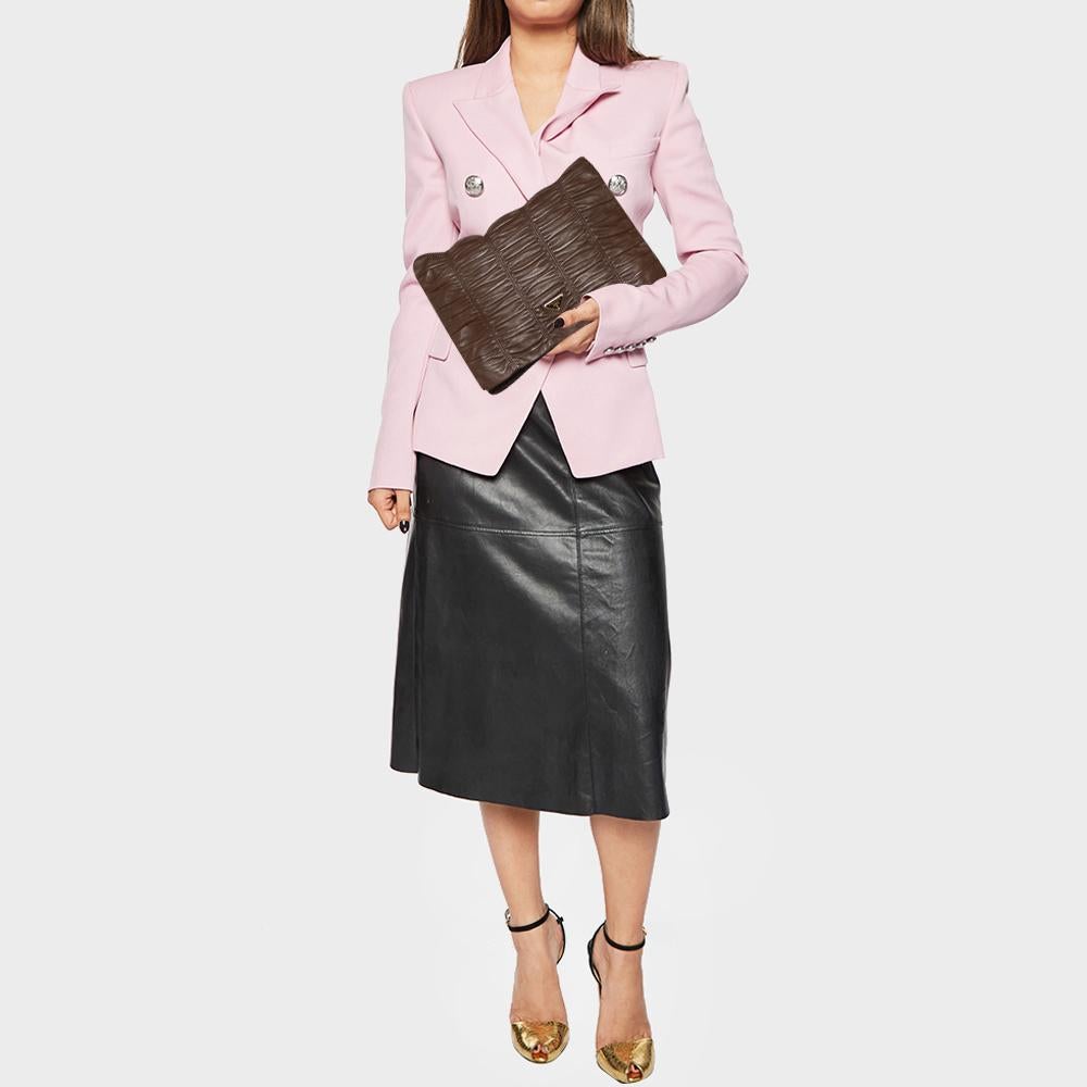 A stylish clutch is a closet staple for all fashionistas! This clutch from the house of Prada is crafted from brown Nappa Gaufre leather. It is equipped with a flap closure and a well-sized compartment for maximum ease.

Includes: Authenticity Card