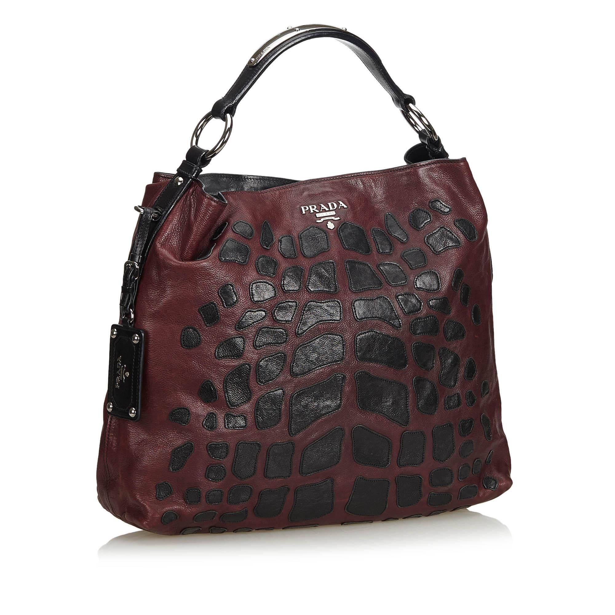 This tote features Nappa leather, flat shoulder straps, patchwork detailing, an open top with a magnetic closure, nylon lining, and interior slip and zip pockets. It carries as B condition rating.

Inclusions: 
This item does not come with