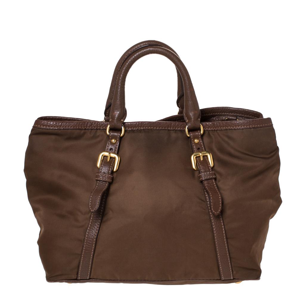 This Prada tote will instantly elevate the look of any outfit. Expertly crafted from nylon and leather, this one exhibits an exquisite design. The interior is also lined with nylon to give it a mix of style and durability. Carry this brown bag to