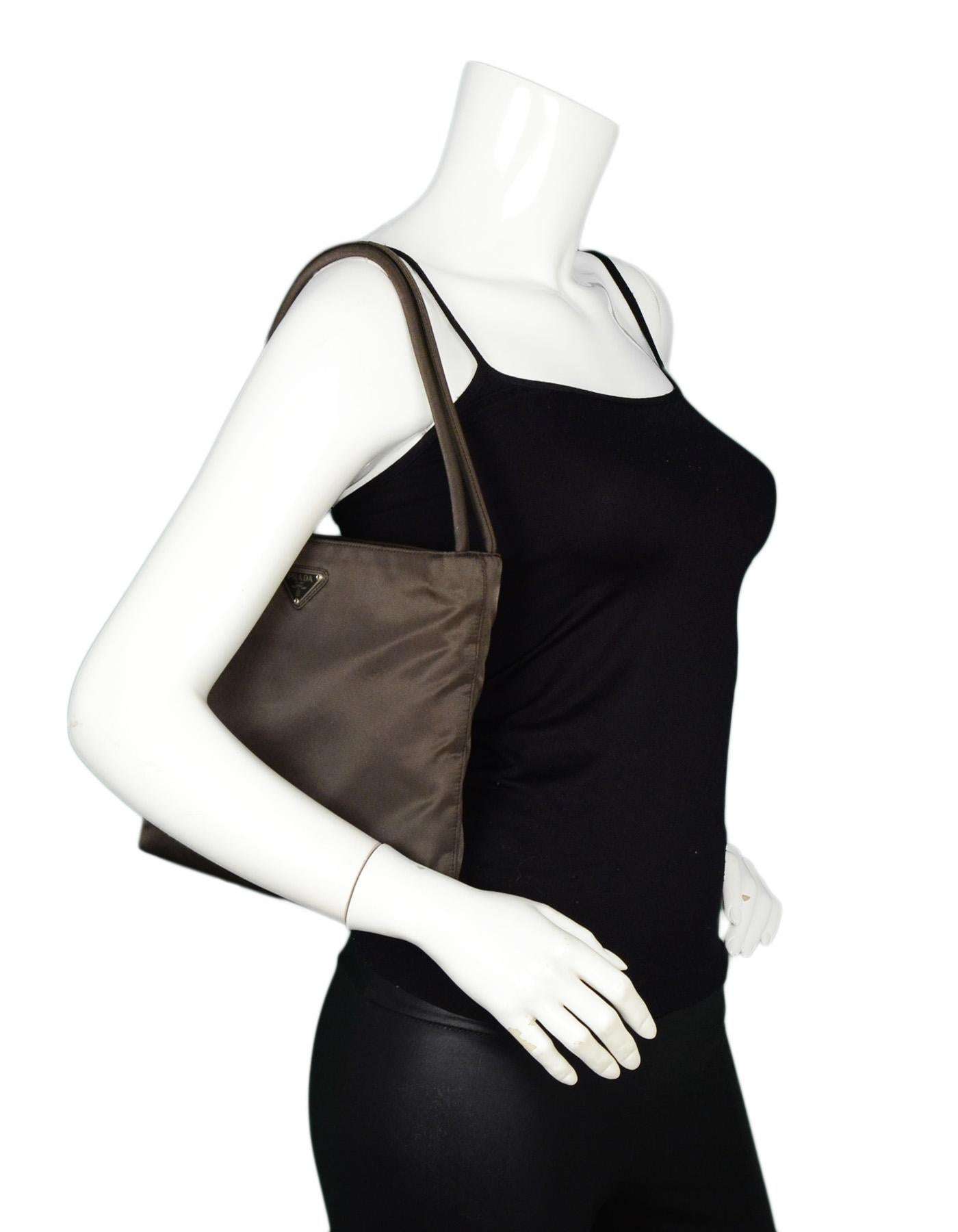 Prada Brown Nylon Double Strap Shoulder Bag

Made In: Italy
Color: Brown
Hardware: Silvertone hardware
Materials: Nylon
Lining: Brown monogram textile
Closure/Opening: Open top
Exterior Pockets: N/A
Interior Pockets: Two compartments, two slit