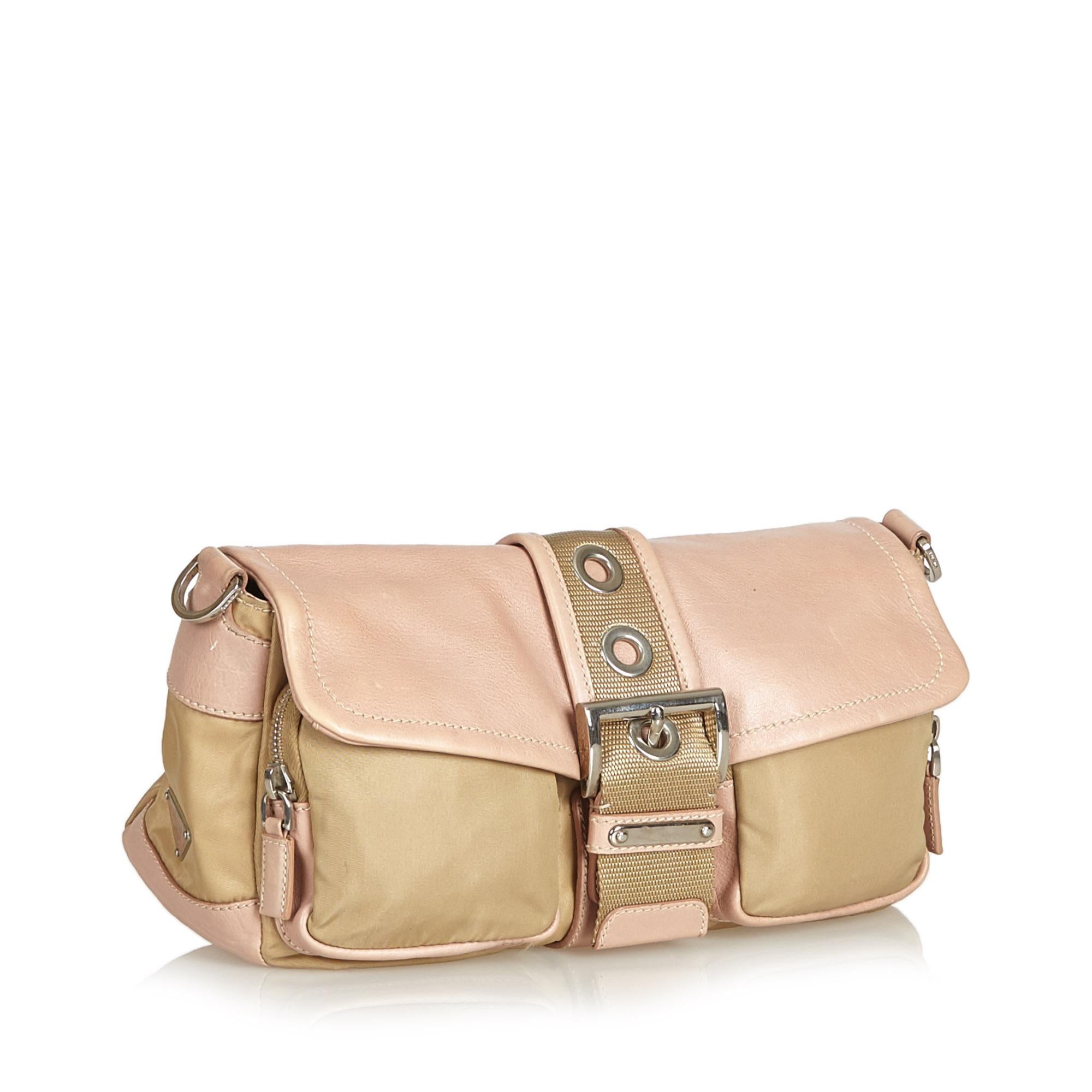 This shoulder bag features a nylon body, front exterior zip pockets, a flat leather strap, and an open top with a magnetic belt closure, It carries as B condition rating.

Inclusions: 
This item does not come with inclusions.

Dimensions:
Length: