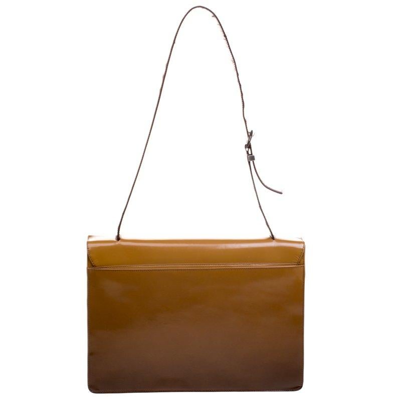 Ideal for everyday use, this shoulder bag is from Prada. It has been crafted from patent leather in an ombre shade and styled with an adjustable shoulder strap. The bag comes with a flap that open to a spacious nylon interior.

Includes: Packaging

