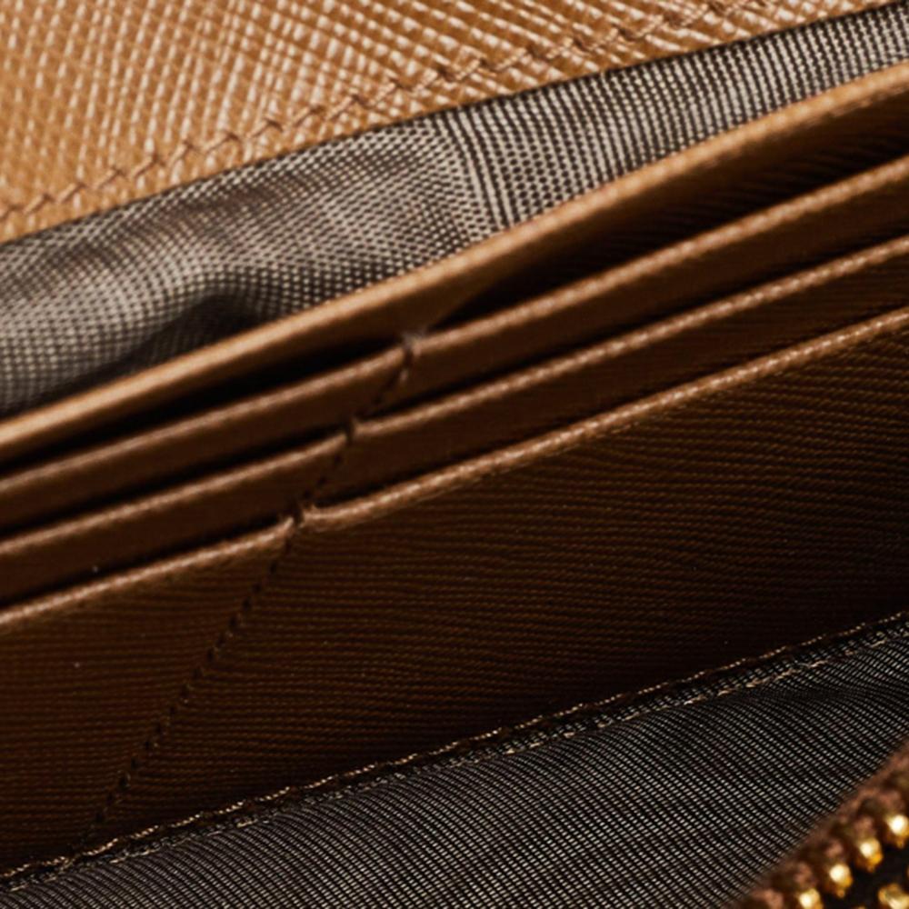 This wallet is a one-stop destination for all your needs! From a luxurious appearance to essential practicality, this wallet offers the whole package. It is created using brown Saffiano leather and features the gold-toned logo on the flap. Add a