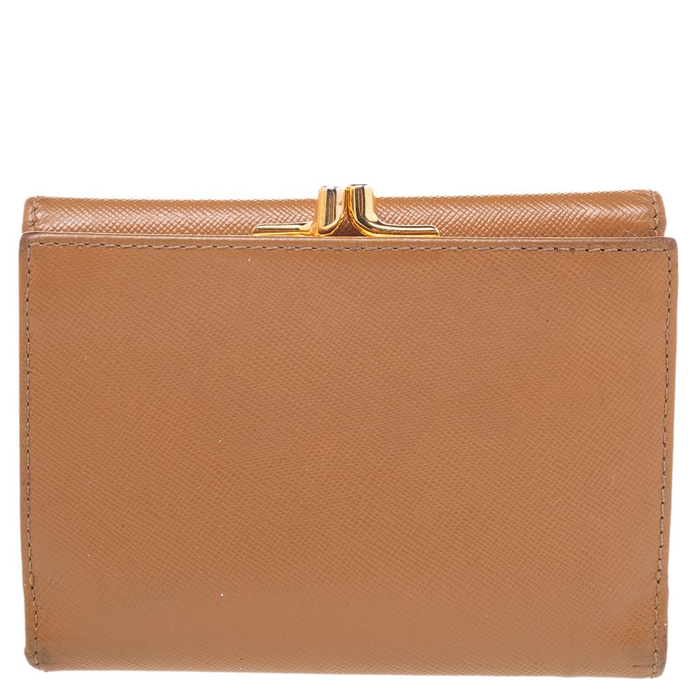Easily carry your necessities as you step out to run errands or attend events. This tri-fold wallet is made with brown Saffiano leather and features an interior that grants several alternatives for storage. This Prada piece is completed with