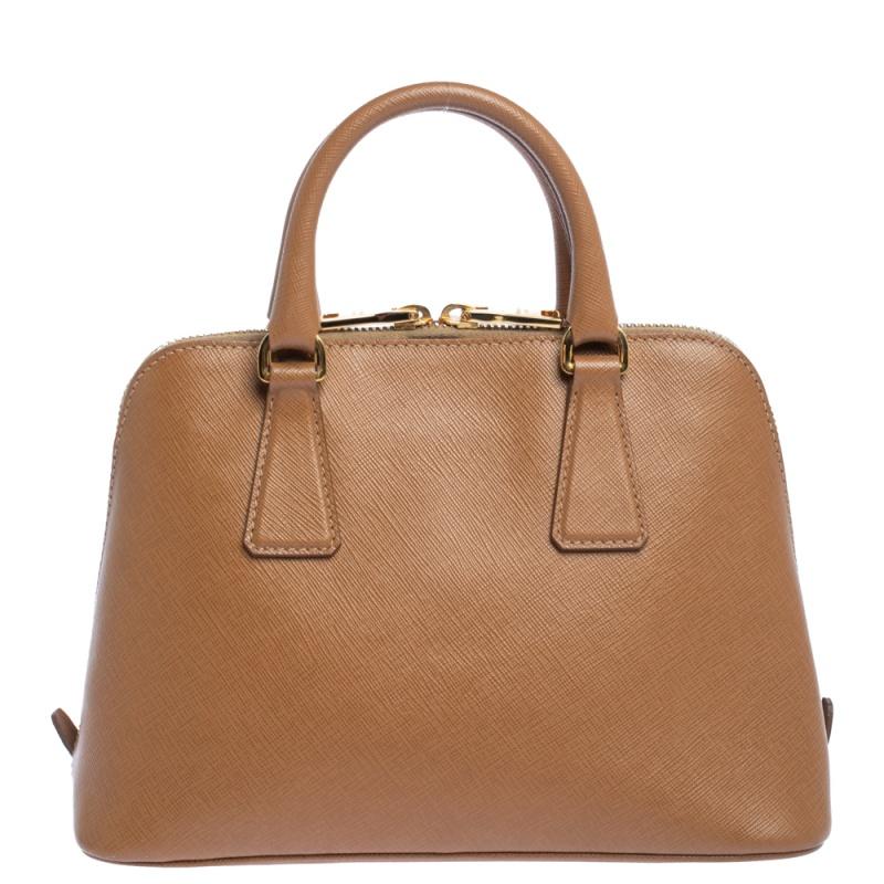 This stunning Promenade tote is high on appeal and style. Dazzling in a classy brown shade, the bag is crafted from leather and features two rolled handles. The zip closure leads way to a nylon interior with enough space for your essentials and the