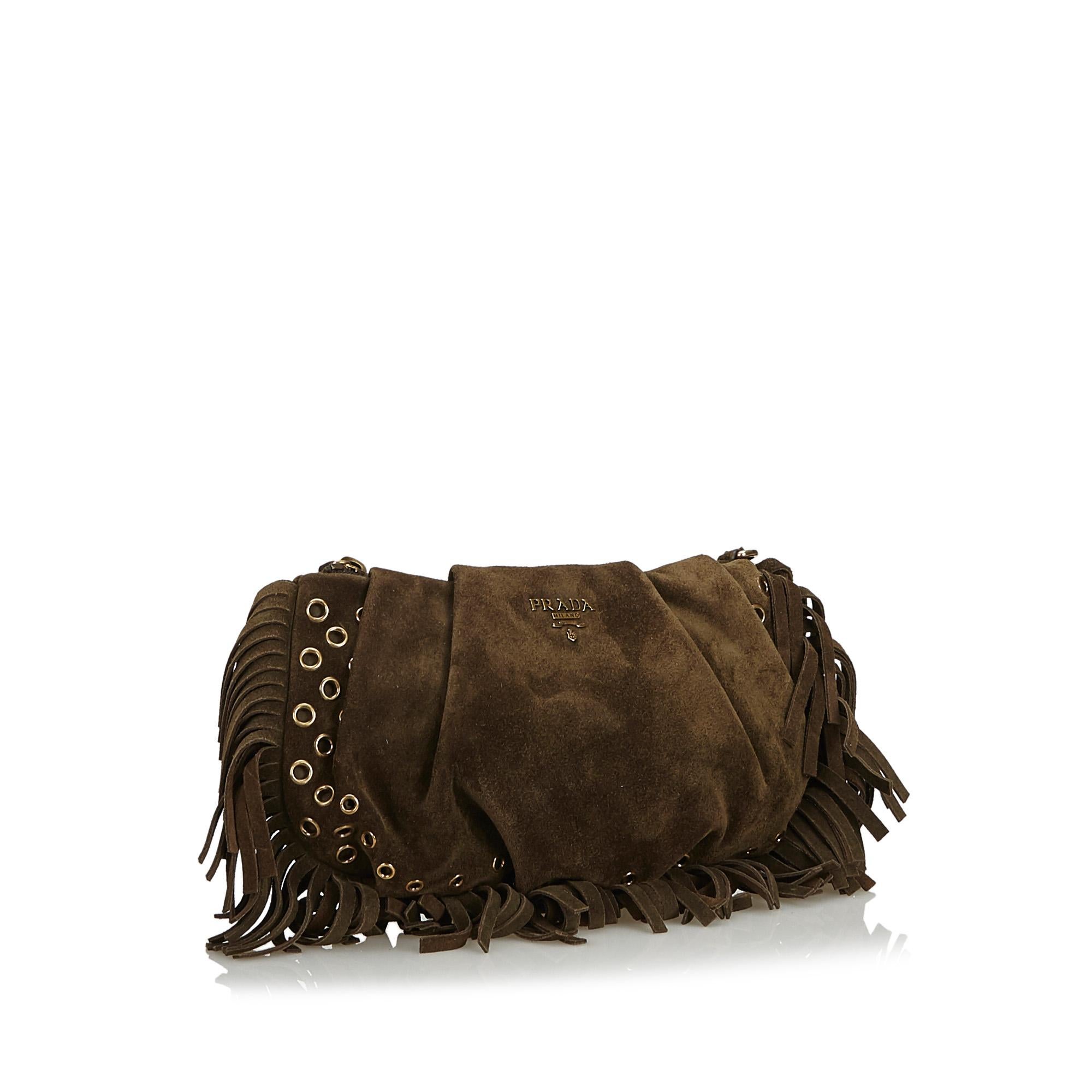 This clutch bag features a suede body with metal accents and fringe details, a top zip closure, and an interior zip pocket. It carries as B+ condition rating.

Inclusions: 
Box
Authenticity Card

Dimensions:
Length: 14.00 cm
Width: 24.00 cm
Depth: