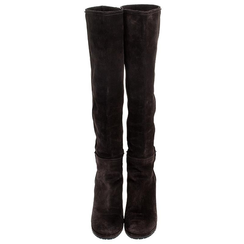 Simple and sophisticated, these knee-length boots from Prada are a must-buy for the fashionable you. These brown boots are crafted in suede and come balanced on wedge heels. They can be paired with a long tunic or an oversized shirt to make quite a
