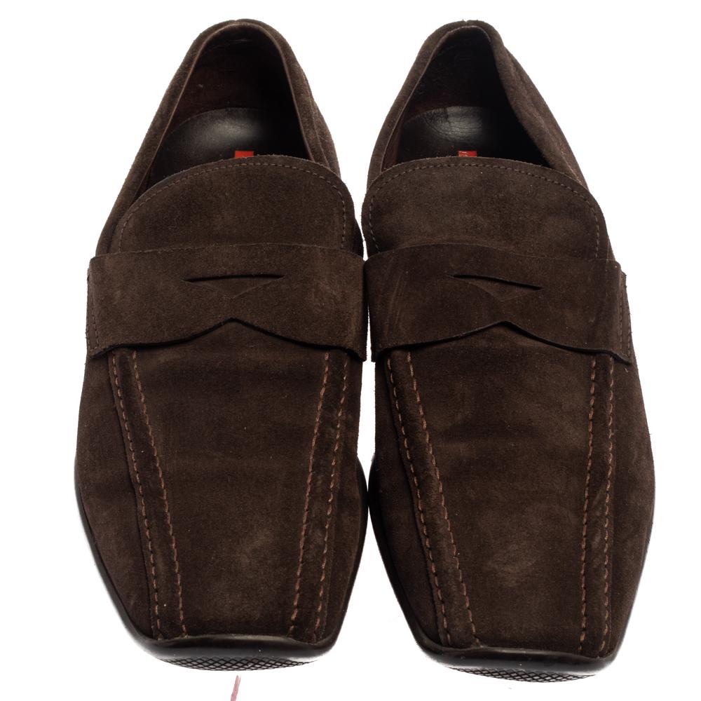 Stylish and super comfortable, this pair of loafers by Prada will make a great addition to your shoe collection. They have been crafted from suede and styled with Penny keeper straps. Leather insoles and rubber outsoles beautifully complete the