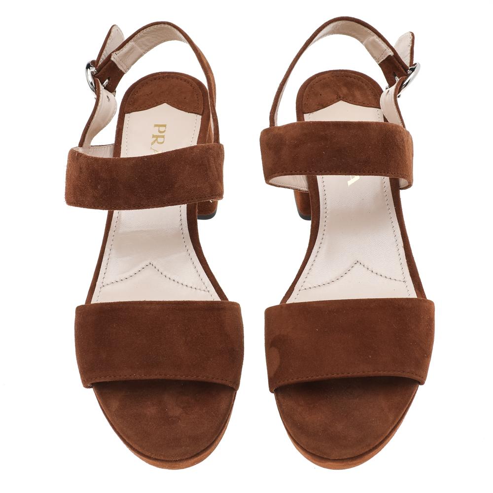 These brown sandals from Prada will lift you with ease. Crafted in Italy, they are made from suede into a lovely silhouette. They feature open toes, platforms, buckled ankle straps, and 6.5 cm block heels.

