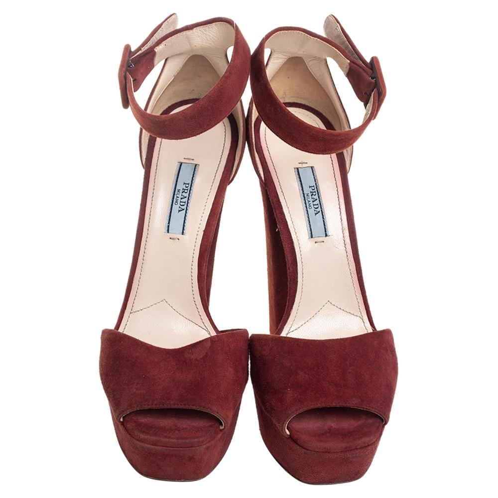 These brown sandals from Prada will lift you with ease. Crafted in Italy, they are made from suede into a lovely silhouette. They feature open toes, platforms, buckled ankle straps, and 14 cm block heels.

