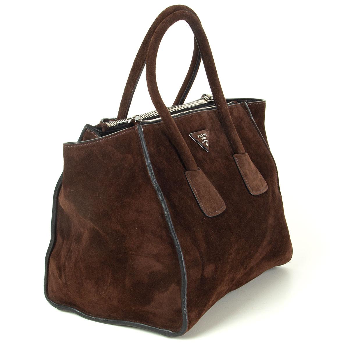 Prada 'Twin Pocket' tote in Mogano (dark brown) Scamosciato suede featuring silver-tone hardware. Opens with a push-button and is lined in smooth black lambskin with two extra large zip pockets on the side, a small zip pocket against the back and a