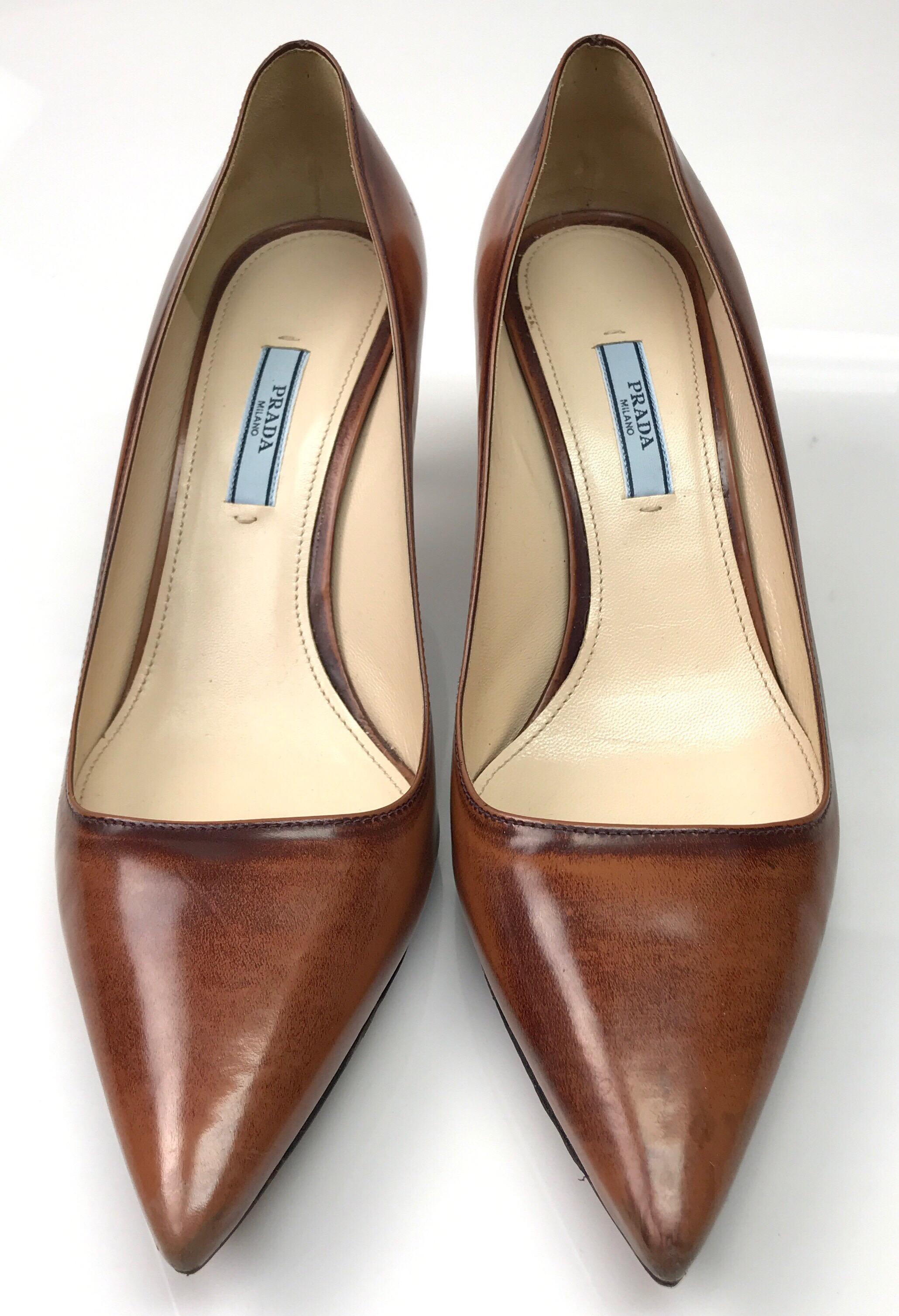 PRADA Brown Unfinished Patent Pointed Toe Heel - 41. This beautiful Prada heel is in excellent condition, only showing sign of use on the bottom of the shoe. It is brown patent leather with an unfinished look. It has a pointed toe and the inside is