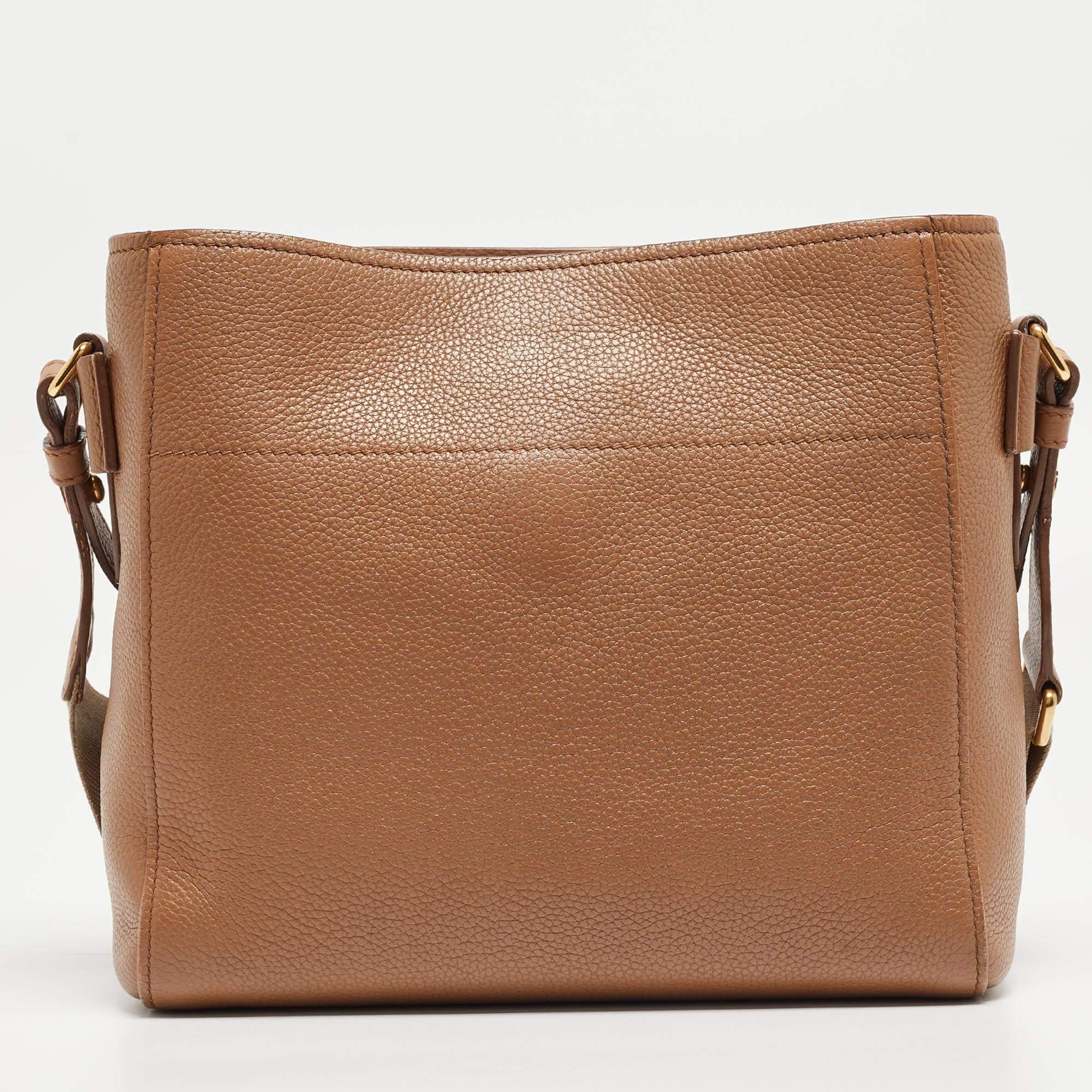 This bag from Prada adds a signature touch to your outfit and elevates its trend quotient. A piece like this brown bag will be your go-to for most of the outfits in your closet. Look super cool and trendy by adorning this beautiful leather bag.

