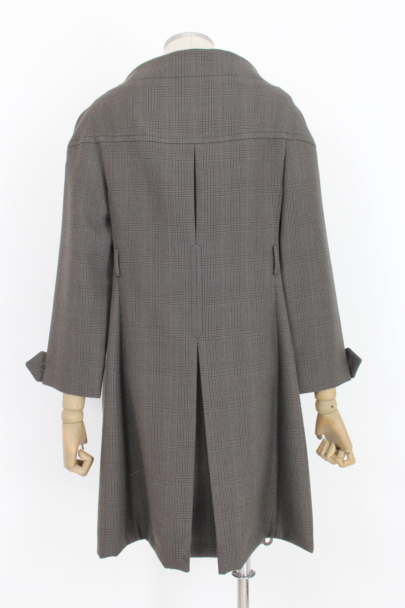 Prada 2000s vintage coat. Double-breasted with brown and blue checked pattern. Round collar, clip button closure, 3/4 sleeve. 100% virgin wool fabric, internally unlined. Made in Italy.

Size: 46 It 12 Us 14 Uk

Shoulder: 46 cm
Bust / Chest: 49