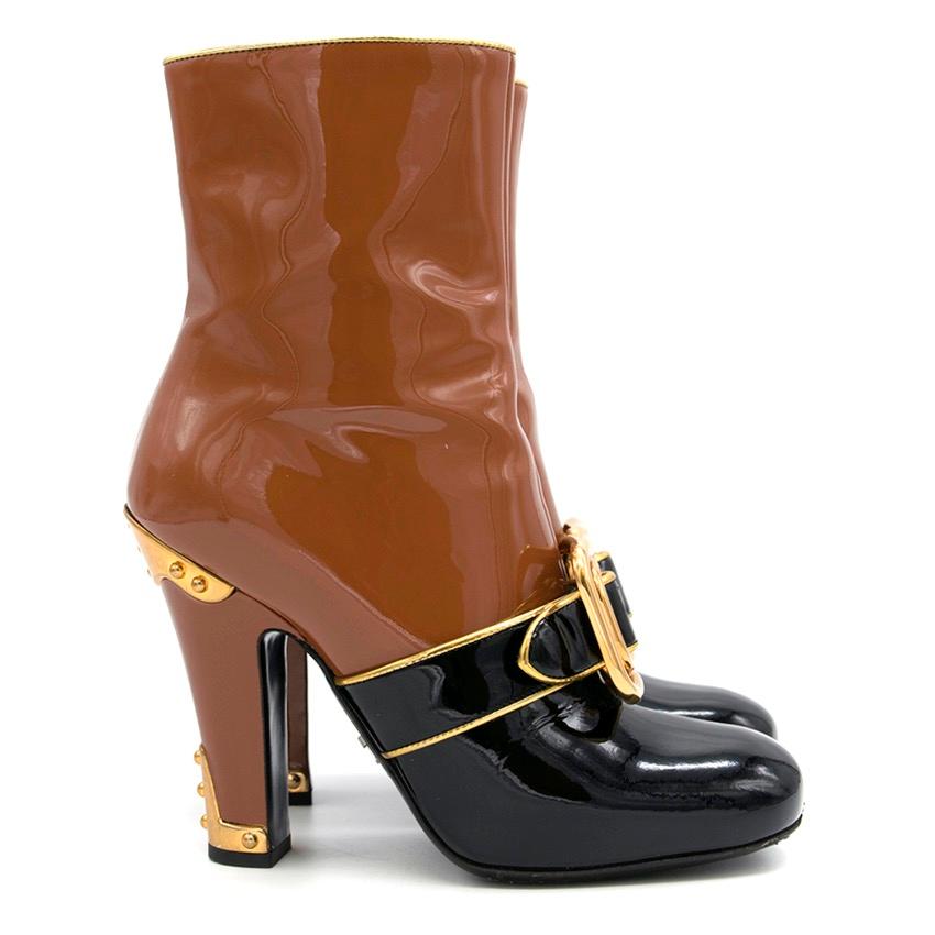 Current Prada Fall 16' two-tone patent leather heeled boots with buckle detailing. The boots feature glossy patent-leather, embellished with oversized buckles, square toe, gold hardware on back of heel, pipping and Zip fastening alongside.

SIZE