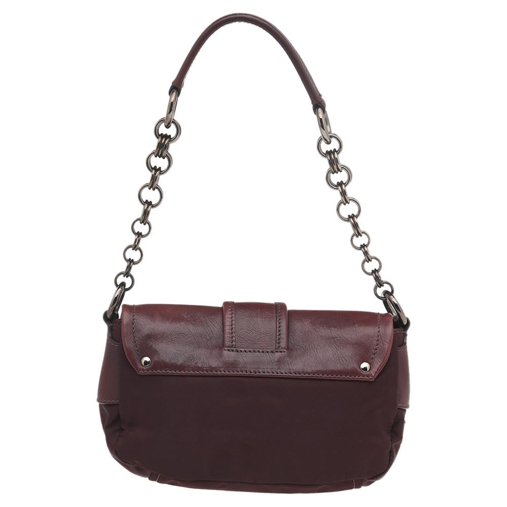 This fabulous leather & nylon bag is artistically designed to help express your style. The bag has a buckle flap, gun-tone hardware, and a single handle. Its nylon interior is well-sized, making it both stylish and practical. This black Prada bag is