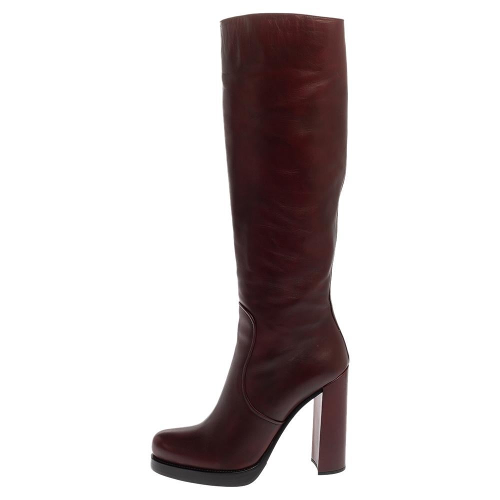 Prada elevates your style quotient by giving you just the right amount of luxury with this gorgeous pair of burgundy leather boots. They are cut to a knee-length and feature closed toes, zippers in silver-tone, and 13 cm heels.

Includes: Original