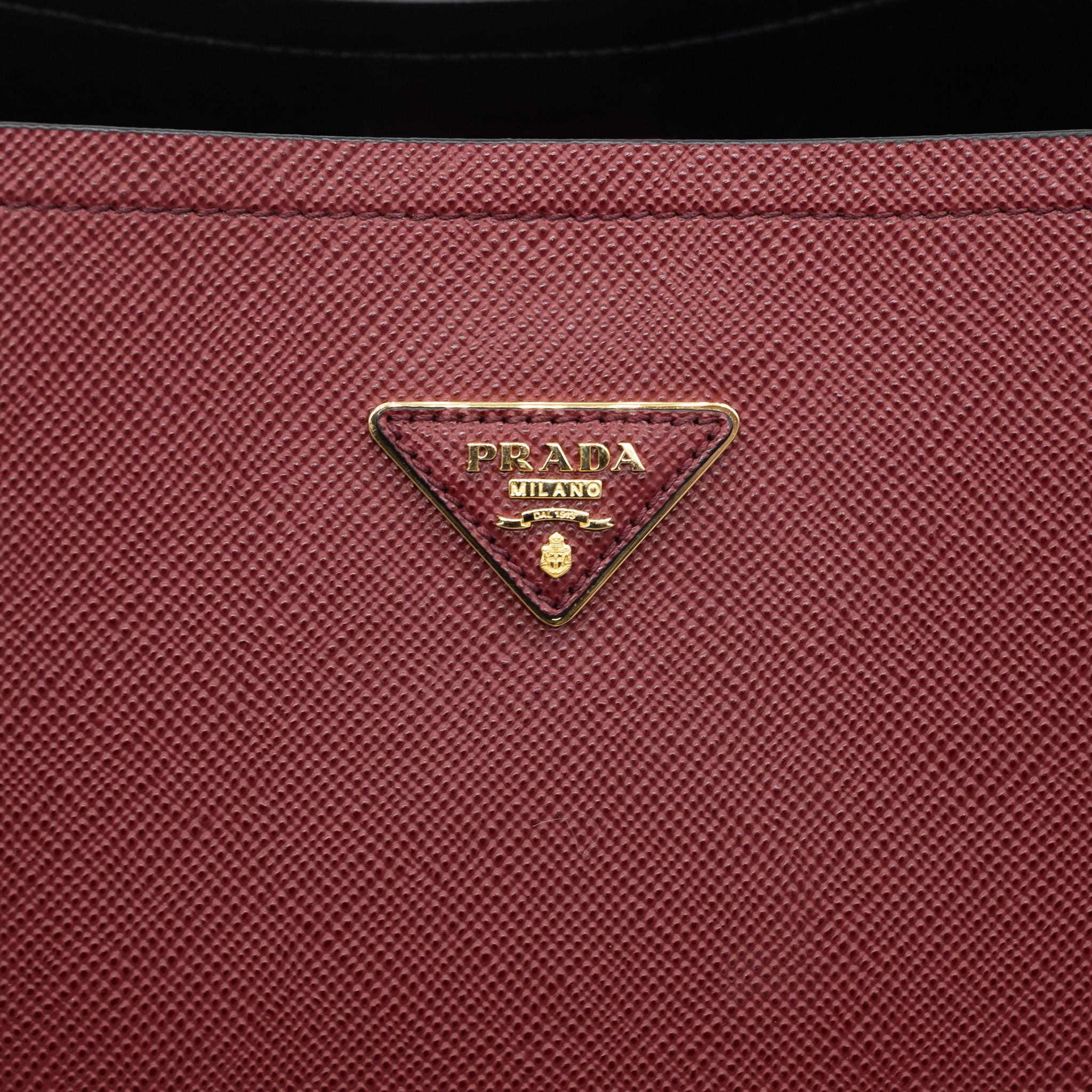 Prada Burgundy Matinée Large Saffiano Leather Crossbody Top Handle Bag, 2020. The traditional rounded edge shape of Prada's Matinée bag is a classic yet trendy take on the Prada bag for the new year. This bag was hand crafted in Italy from Prada's