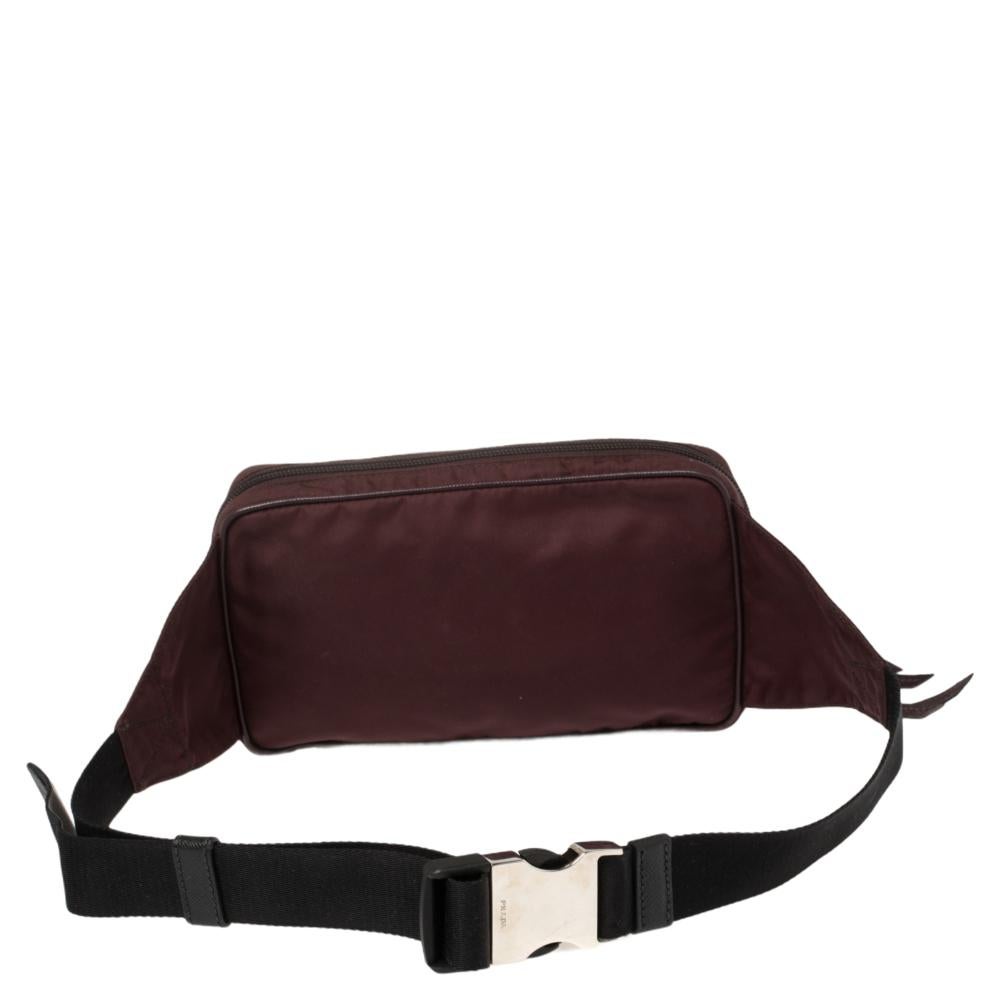 The waist bag trend is one we are loving! This one from Prada is a fine choice for you to join the trend. Made from nylon & leather, the burgundy bag comes with zipped compartments and brand detail on the front. It is finished with a buckled
