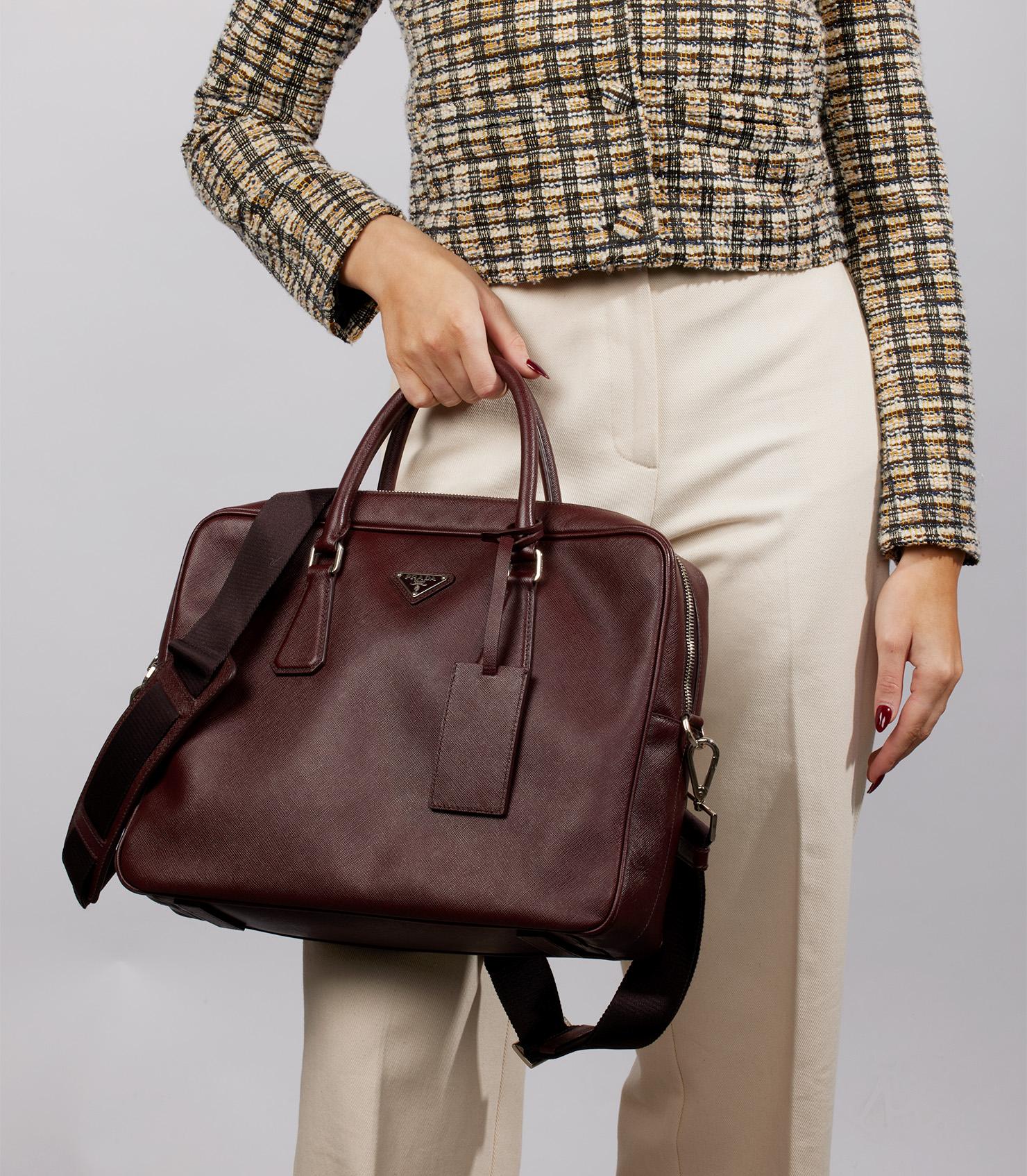 Prada Burgundy Saffiano Leather Work Bag 

Product Details
Xupes Ref: CB1005
Brand: Prada
Model: Work Bag
Type: Tote, Shoulder 
Serial Number: 208
Accompanied By: Prada Dust Bag, Shoulder Strap, Clochette
Colour: Burgundy 
Hardware: