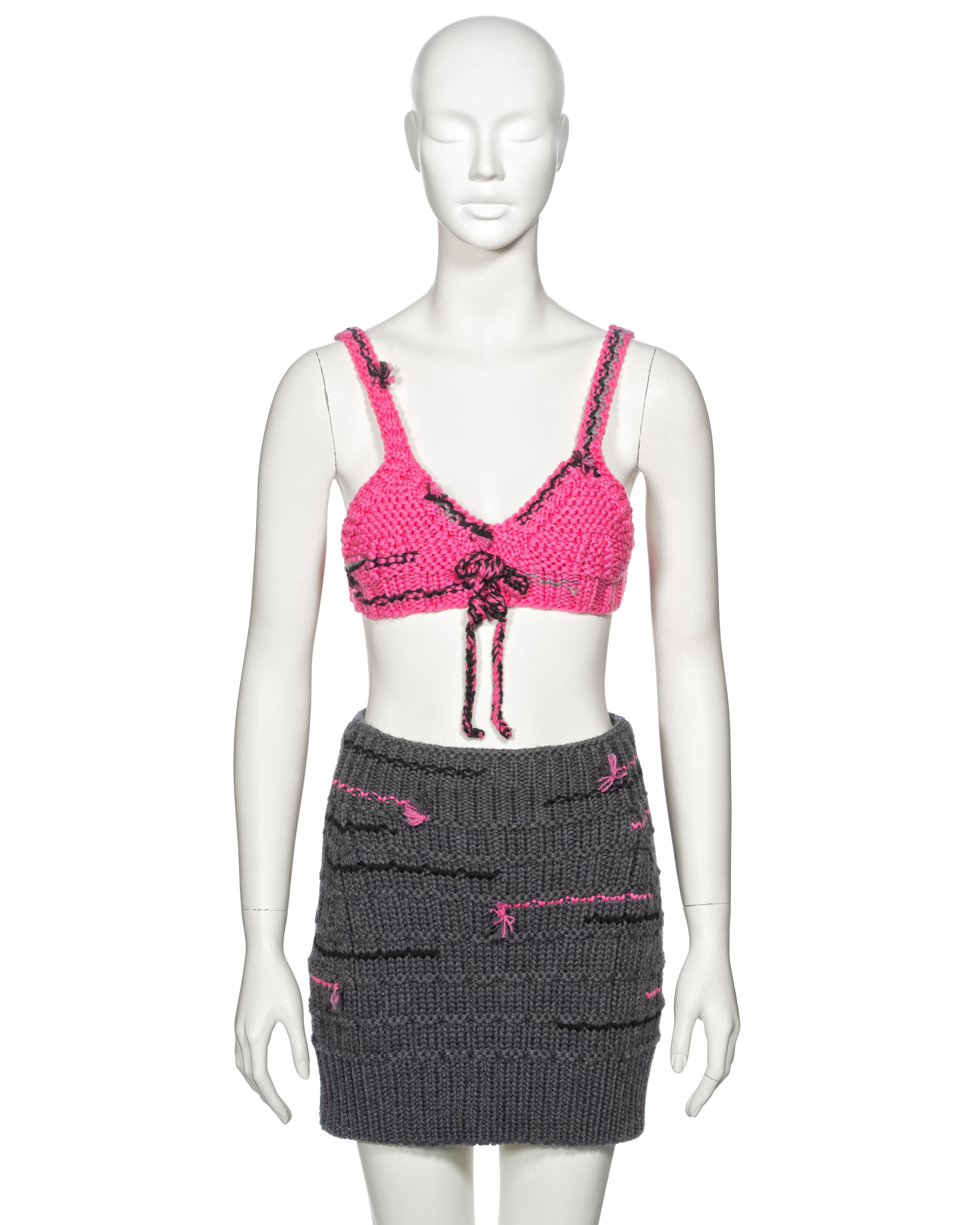 ▪ Prada Knitted Bra and Skirt Set
▪ Creative Director: Miuccia Prada
▪ Fall-Winter 2017
▪ Sold by One of a Kind Archive
▪ Pink knitted bra top 
▪ Snap button closures
▪ Grey knitted mini skirt 
▪ Fabric: 100% Pure New Wool
▪ Top: IT40 - FR36 - UK8 -
