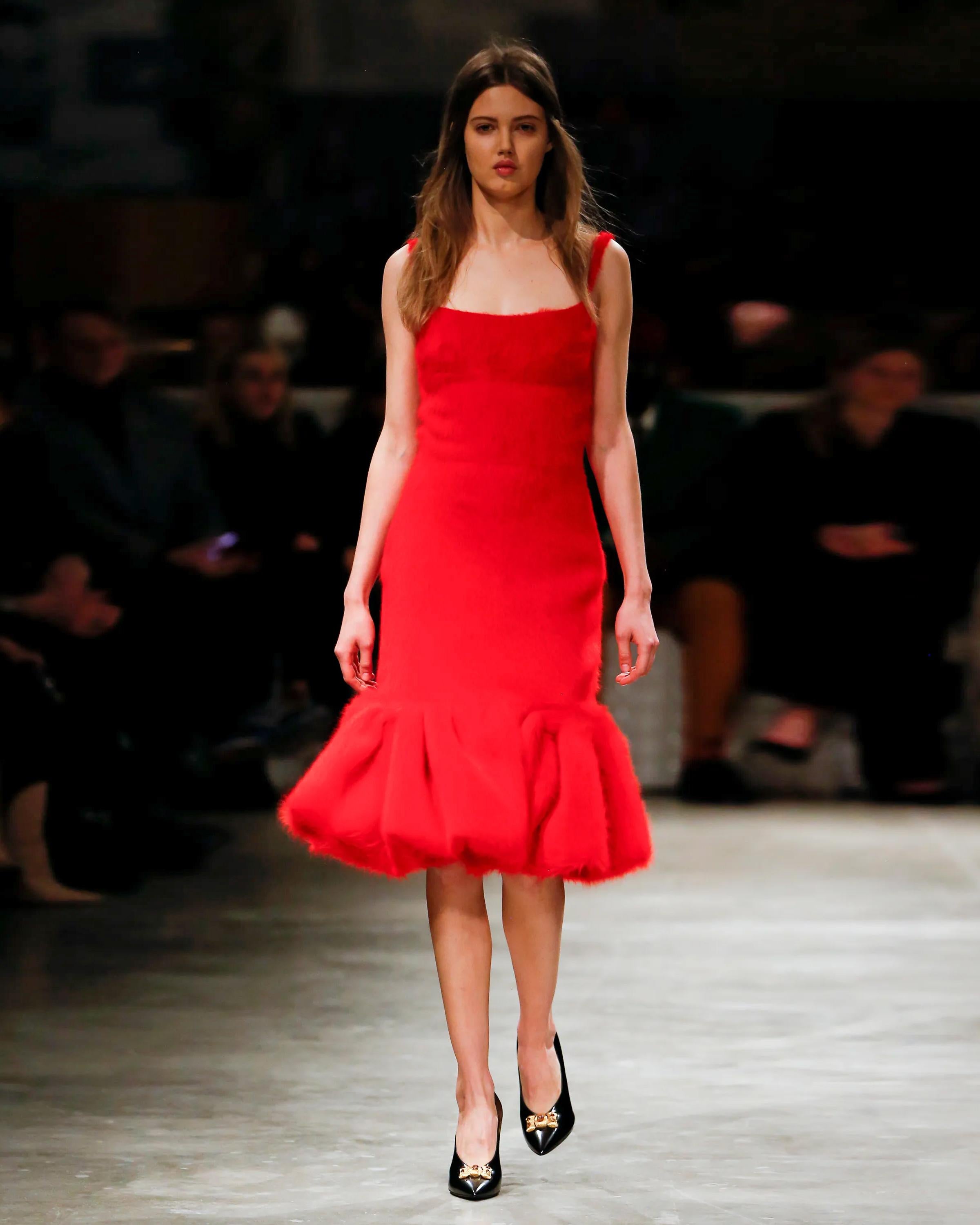 ▪ Runway Prada Red Cocktail Dress
▪ Creative Director: Miuccia Prada
▪ Fall-Winter 2017
▪ Crafted from plush red brushed alpaca silk, boasting a luxuriously fuzzy texture
▪ Tailored bodice features a classic square neckline
▪ The skirt descends to