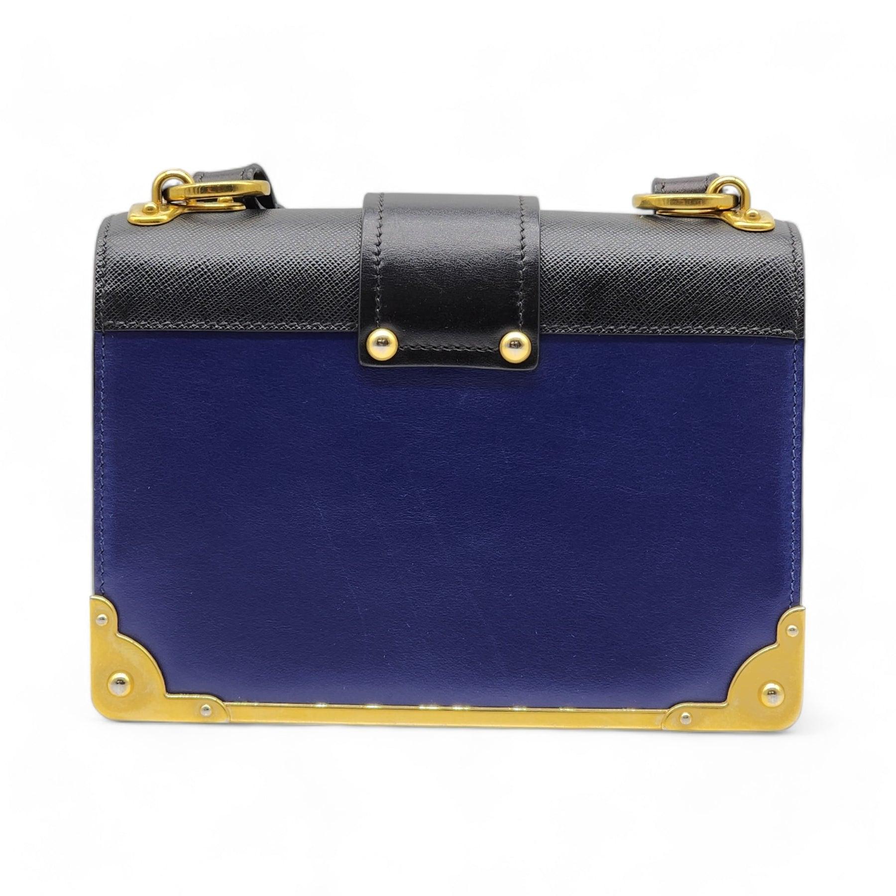 Prada Cahier Crossbody Bag in Blue.

Additional information:
Material: Calfskin leather
Gold-tone Hardware
Color: Blue
Country: Italy
Dimension: 8