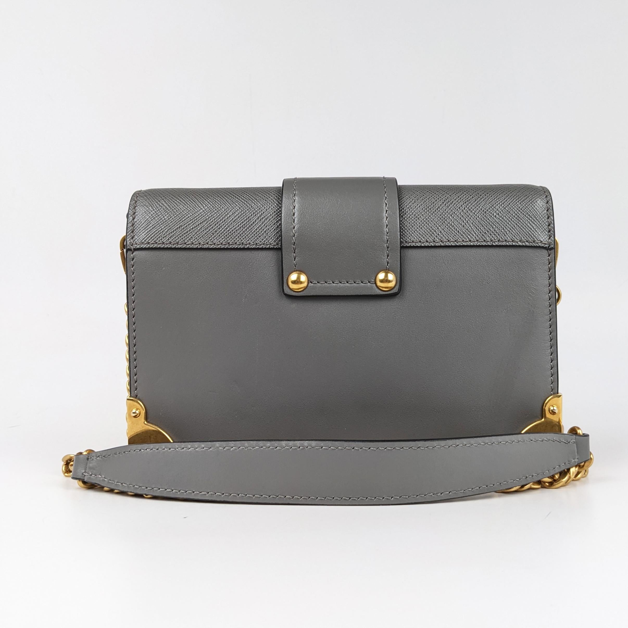 Condition: This authentic Prada bag is in excellent pre-loved condition. There is light tarnishing on the hardware and faint exterior scratches.

Est. Retail: $2850

Includes: Authenticity card

Features: Gold-tone embellishments, removable chain