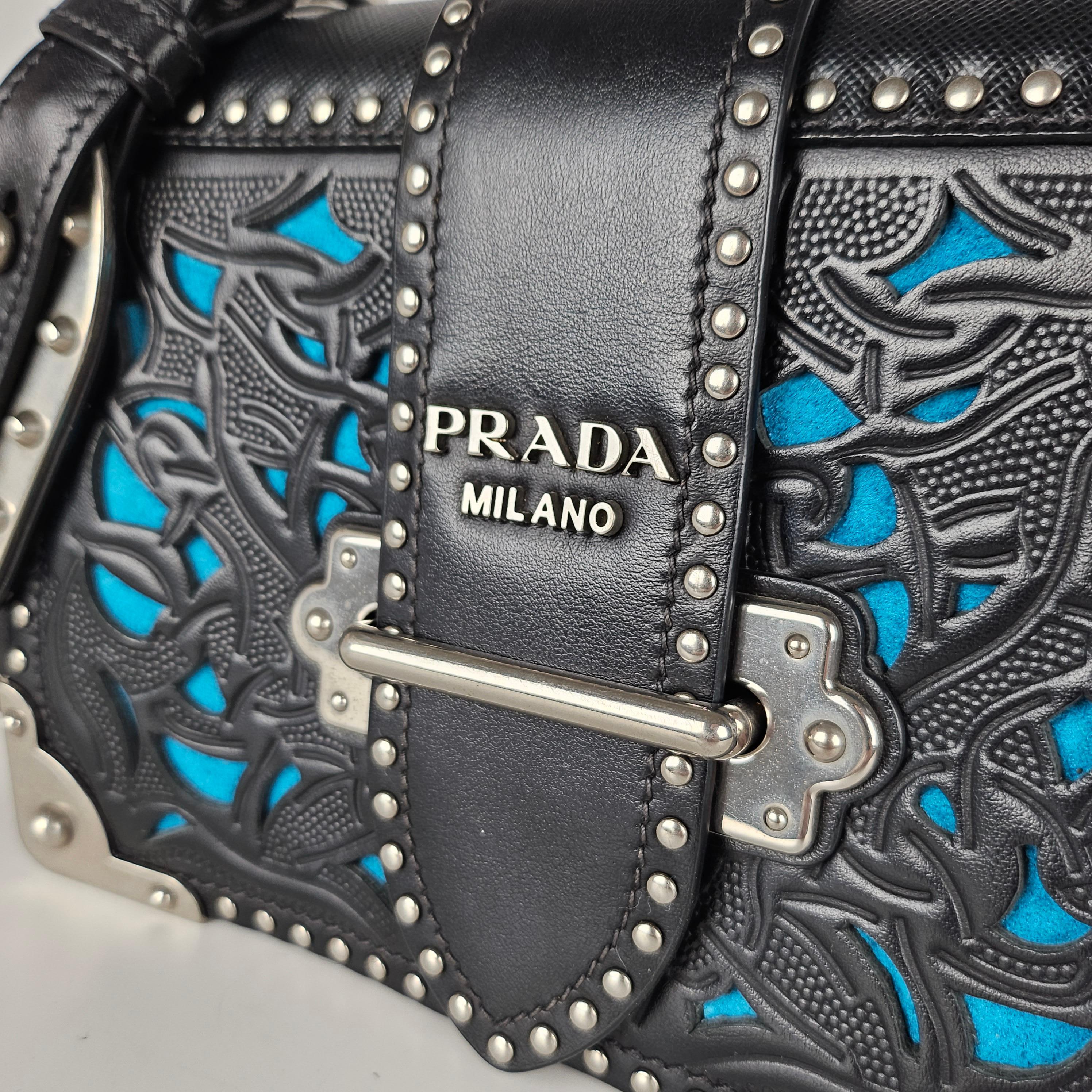 Condition: This authentic Prada bag is in great pre-loved condition. There is minor tarnishing and scratches on hardware and light scratches in the interior.

No accessories included (dust bag, box, etc.)

Features: Adjustable leather strap, laser