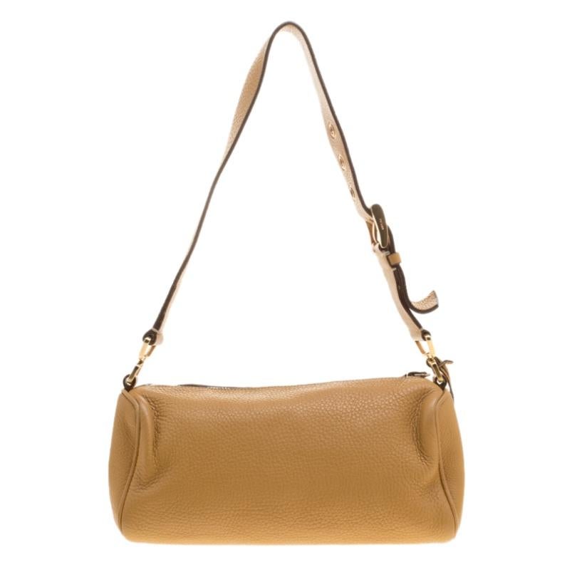 The smooth and subtle hue of this bag will blend perfectly with any dress of your pick. Get your hands on this beautiful leather shoulder bag to nail a picture perfect look. It is from Prada and it is designed with a shoulder strap and a zipper