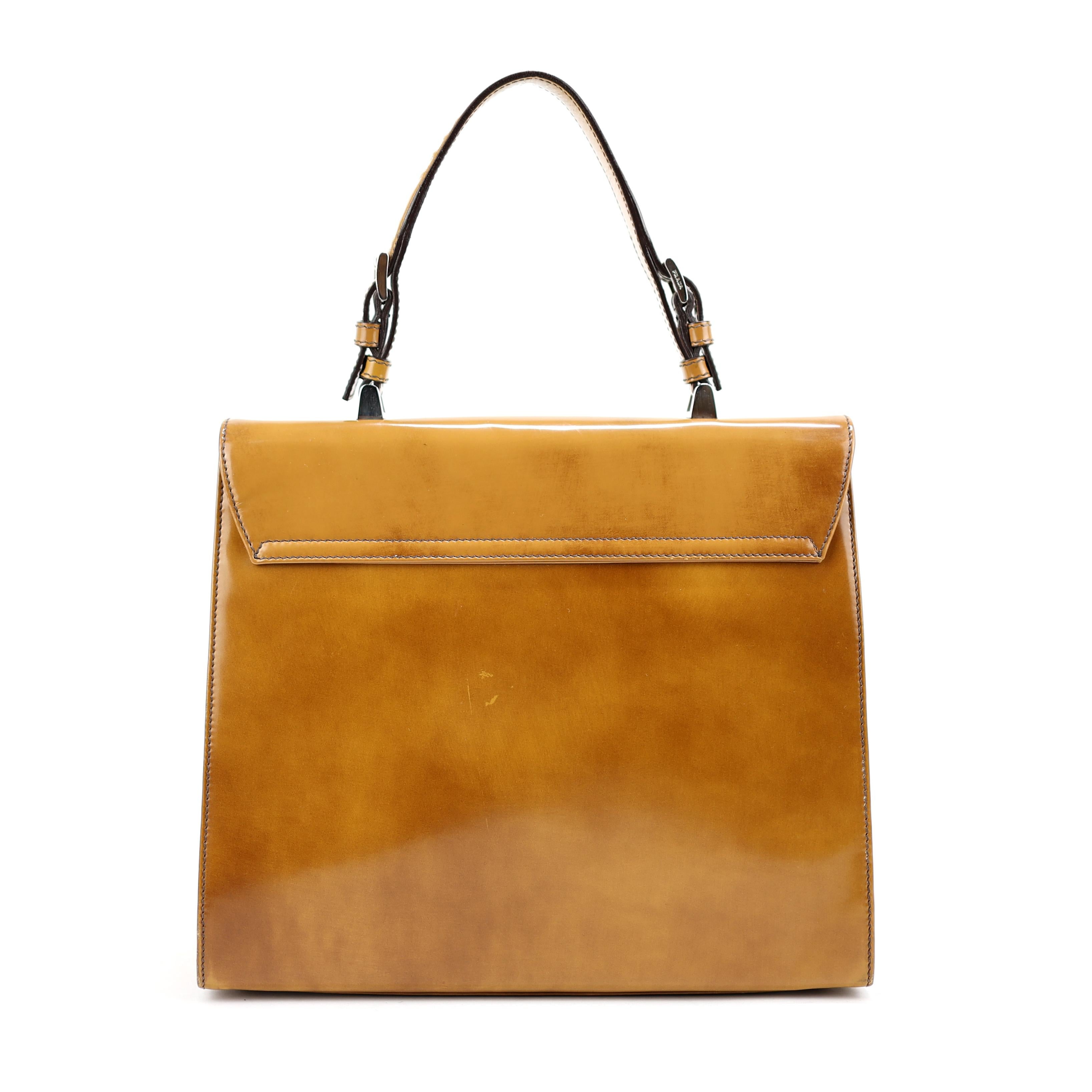 Prada bag in camel-colored Spazzolato leather, doctor shape, orange leather interior. Fun fact: from the same collection of Miranda Priestly Prada bags in the movie Devil Wears Prada. back of the bag and corners slightly