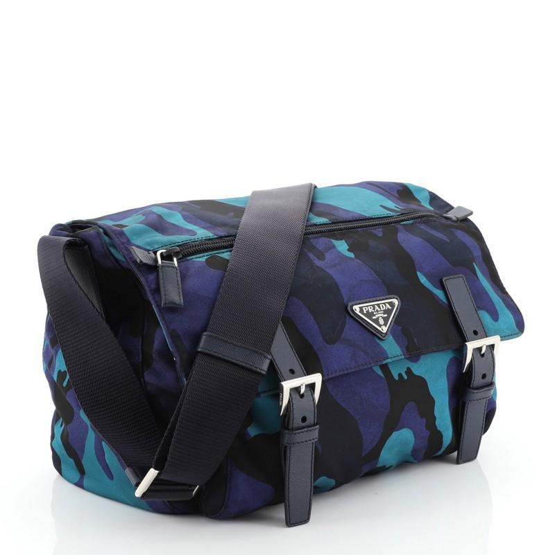 This Prada Camouflage Messenger Bag Printed Tessuto Small, crafted from blue printed nylon, features an adjustable shoulder strap, exterior front zip pocket on flap, and silveer-tone hardware. Its flap and zip closures open to a blue fabric