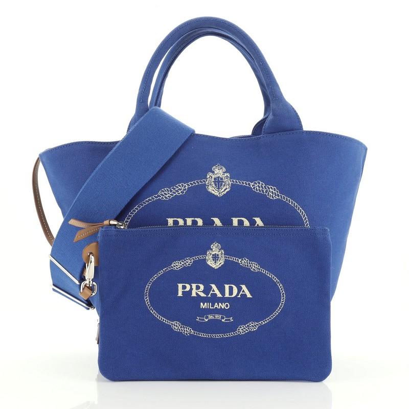 This Prada Canapa Convertible Shopping Tote Canvas Medium, crafted in blue canvas, features dual top handles and silver-tone hardware. It opens to a blue canvas interior with side zip pocket. 

Estimated Retail Price: $1,150
Condition: Excellent.