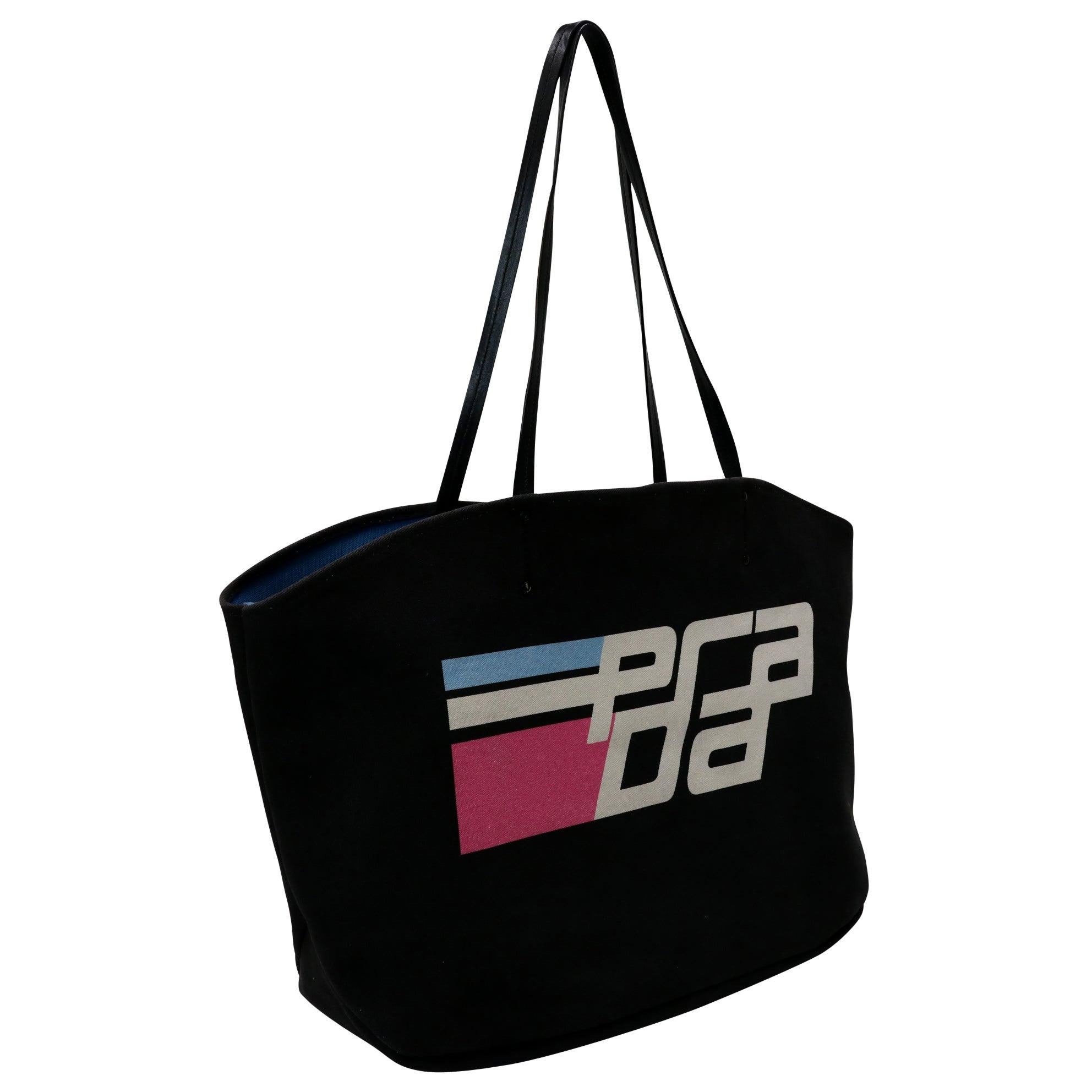 Here is a beautiful Prada large tote bag with racing stripes and a huge PRADA print on the front. This is the perfect handbag for a stylish woman who likes to be noticed. You'll look great and feel great with this Prada bag in your hand includes