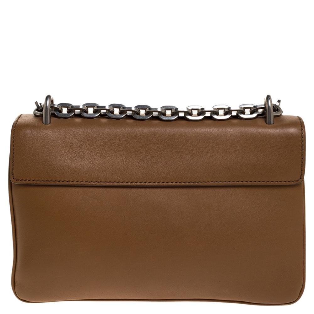 Simple, sleek & sophisticated, this Prada shoulder bag is stunning. Crafted from quality leather, they come in a lovely shade of caramel brown. It has a front flap that carries the logo and opens to a leather-lined interior. It has three
