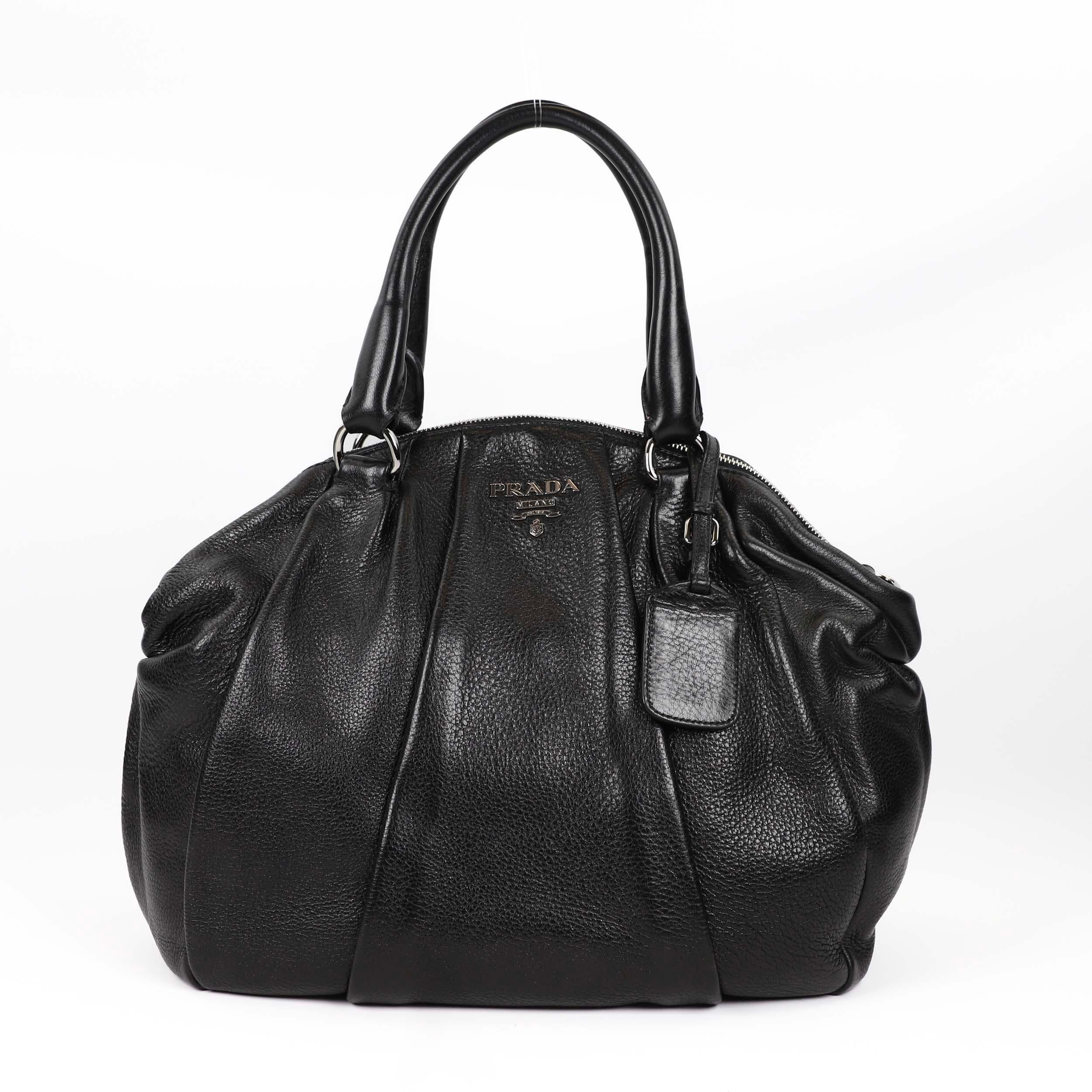This gorgeous piece is not your usual Prada Bag - with its beautiful black colour, yet casual enough to wear every day. The sides of the bag are purposely ruffled to create that laid-back, slouchy aesthetic, which is so cool at the moment. With