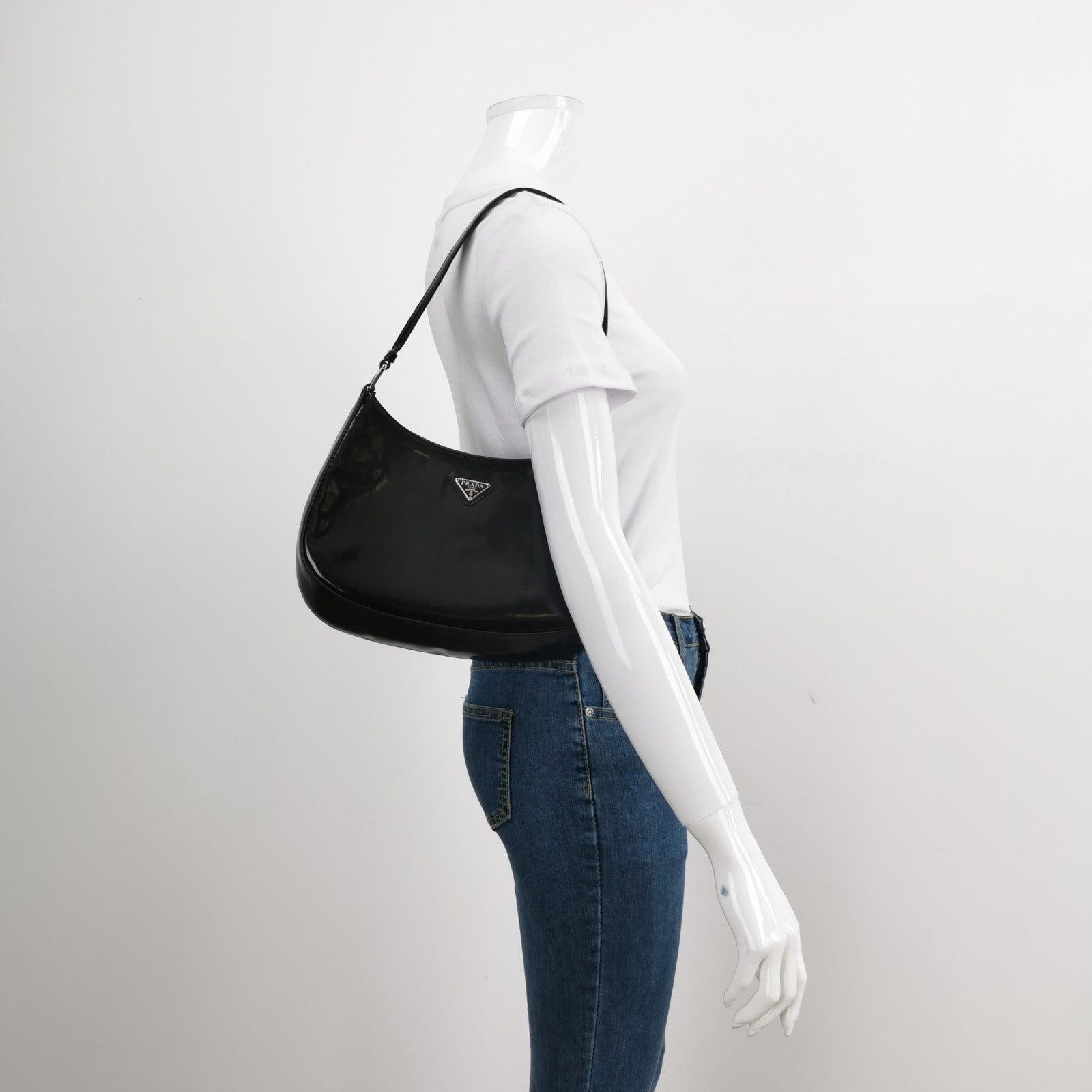 Prada Cleo Black Smooth Leather Shoulder Bag These are professional photos of the actual bag offered by Luxbags. The Prada Cleo Black leather shoulder bag is a timeless classic. It is crafted from a smooth black leather with a mirror glaze shine.