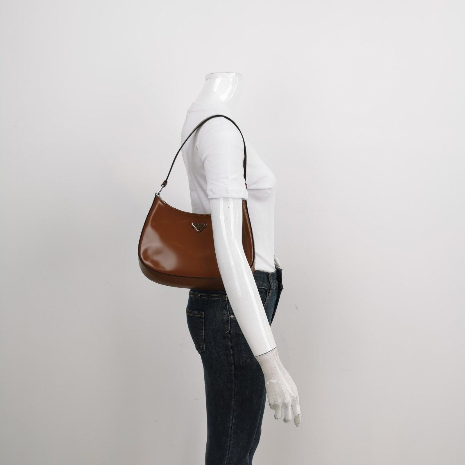 Prada Cleo Caramel Brown Brushed Leather Shoulder Bag These are professional photos of the actual bag offered by Luxbags. The Prada Cleo Silver leather shoulder bag is a timeless classic. It is crafted from a brushed brown leather. Combining luxury