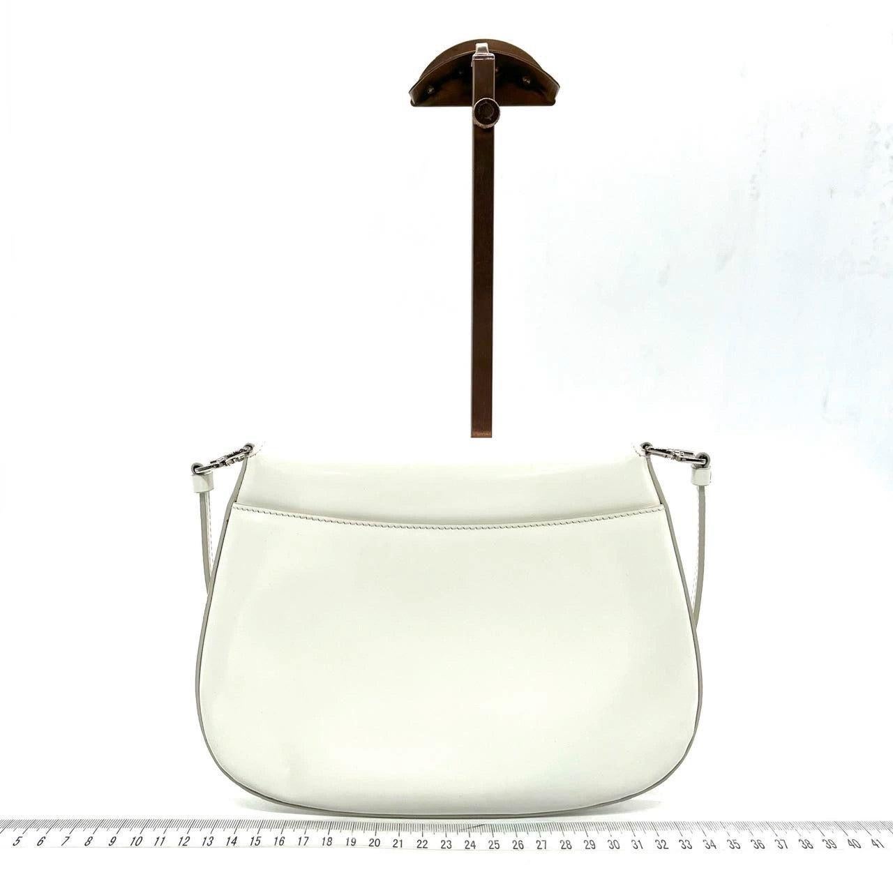Prada Cleo Flap White Leather Shoulder bag
 These are professional photos of the actual bag offered by Luxbags.
 This Prada Cleo Flap Shoulder Bag is the perfect accompaniment for any stylish and sophisticated woman. Crafted from smooth white
