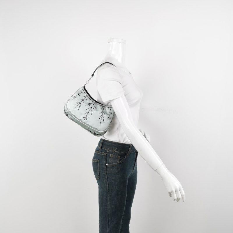 Prada Cleo Vintage Blue Silk Beaded Embroidery Shoulder Bag
  These are professional photos of the actual bag offered by Luxbags.
  The Prada Cleo shoulder bag is a timeless classic. It is crafted from classy light blue silk with black beaded