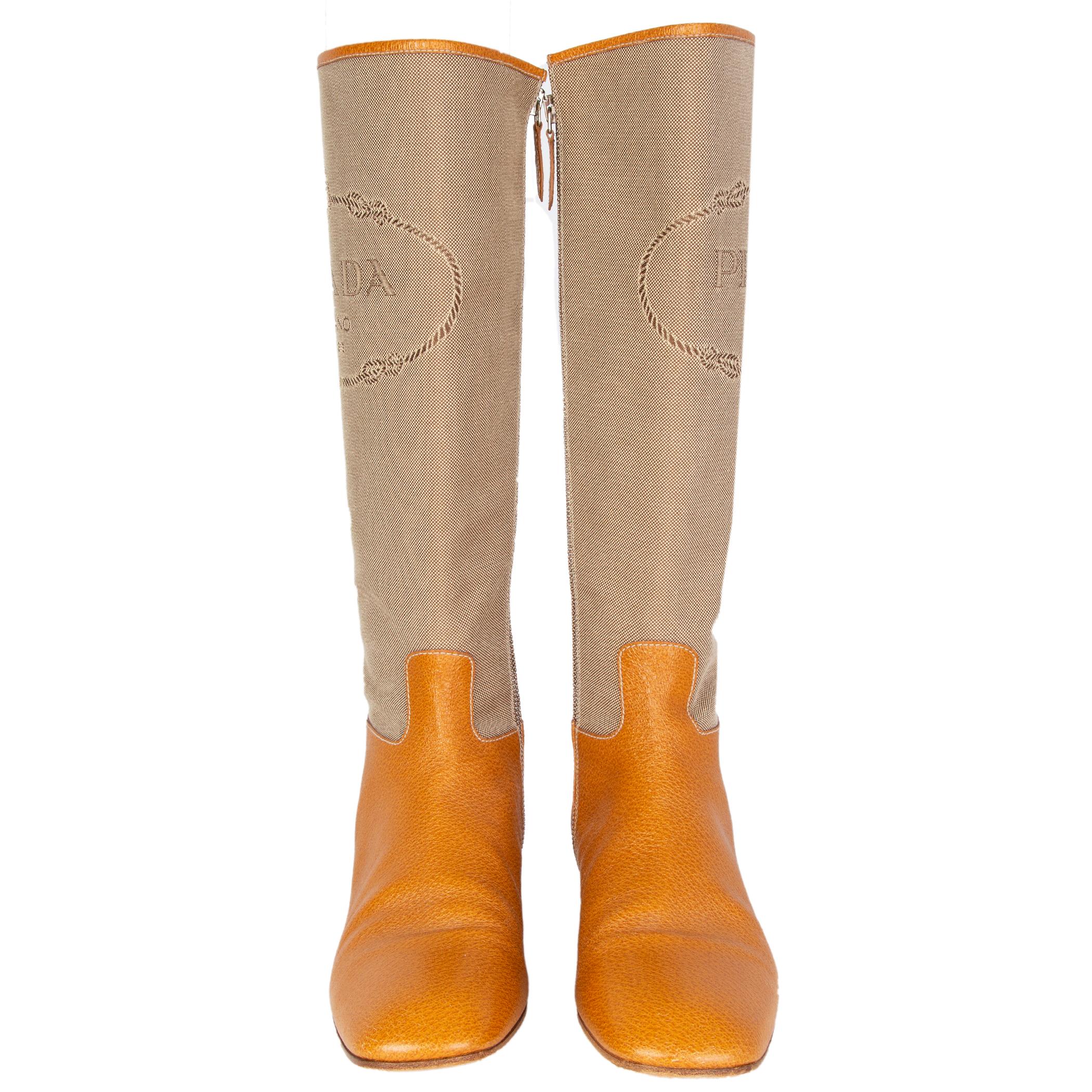 100% authentic Prada flat knee-high boots in cognac leather with beige Jacquard logo canvas shaft. Open with a zipper on the inside. Have been worn are in excellent condition. 

Measurements
Imprinted Size	40
Shoe Size	40
Inside Sole	27cm