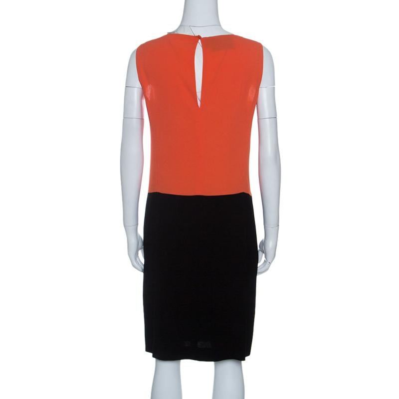 This dress from the house of Prada can easily be dressed up or down with just minimal changes. It is designed in crepe fabric in a color block pattern. The sleeveless style falls just to the knee and secured with a rear button closure. Wear it with