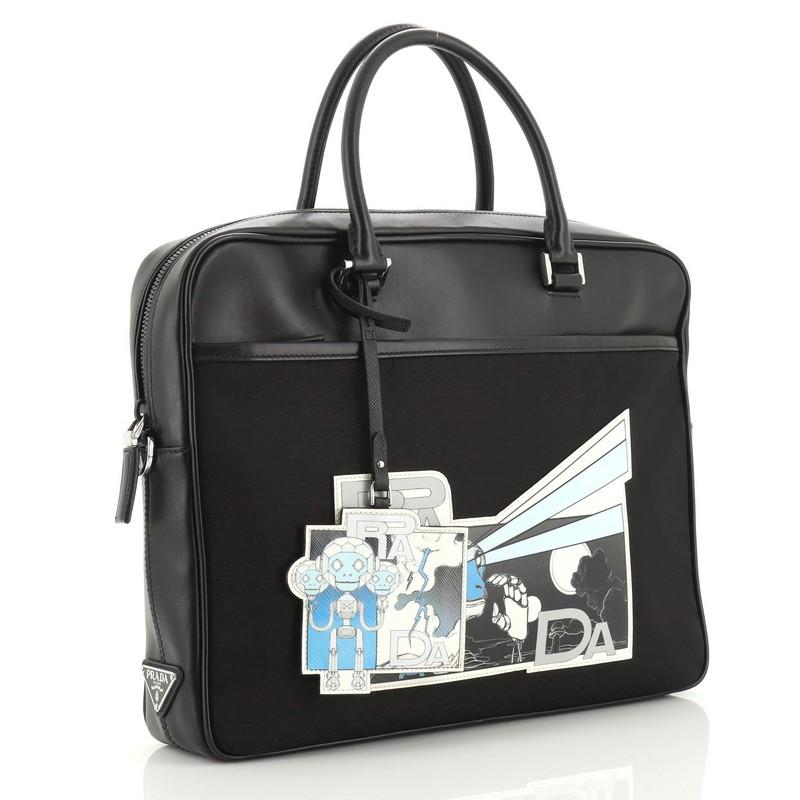 This Prada Comic Briefcase Tessuto with Printed Saffiano, crafted in black nylon, features dual leather handles, comics print at front, exterior front slip pocket and silver-tone hardware. Its zip closure opens to a black fabric