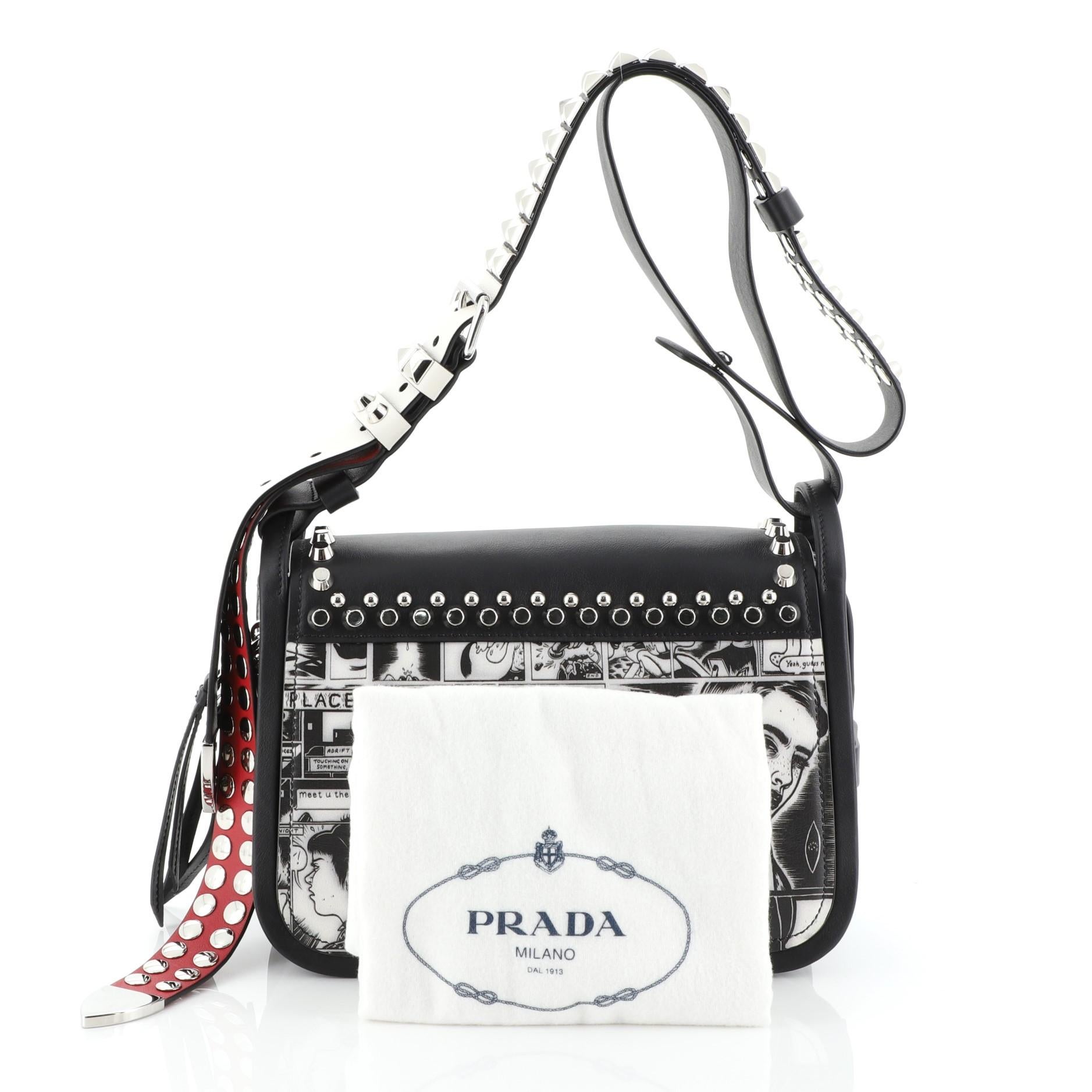 This Prada Concept Flap Shoulder Bag Studded Printed Leather Medium, crafted from black printed leather, features adjustable leather strap, stud detailing and silver-tone hardware. Its flap with magnetic closure opens to a black leather and fabric