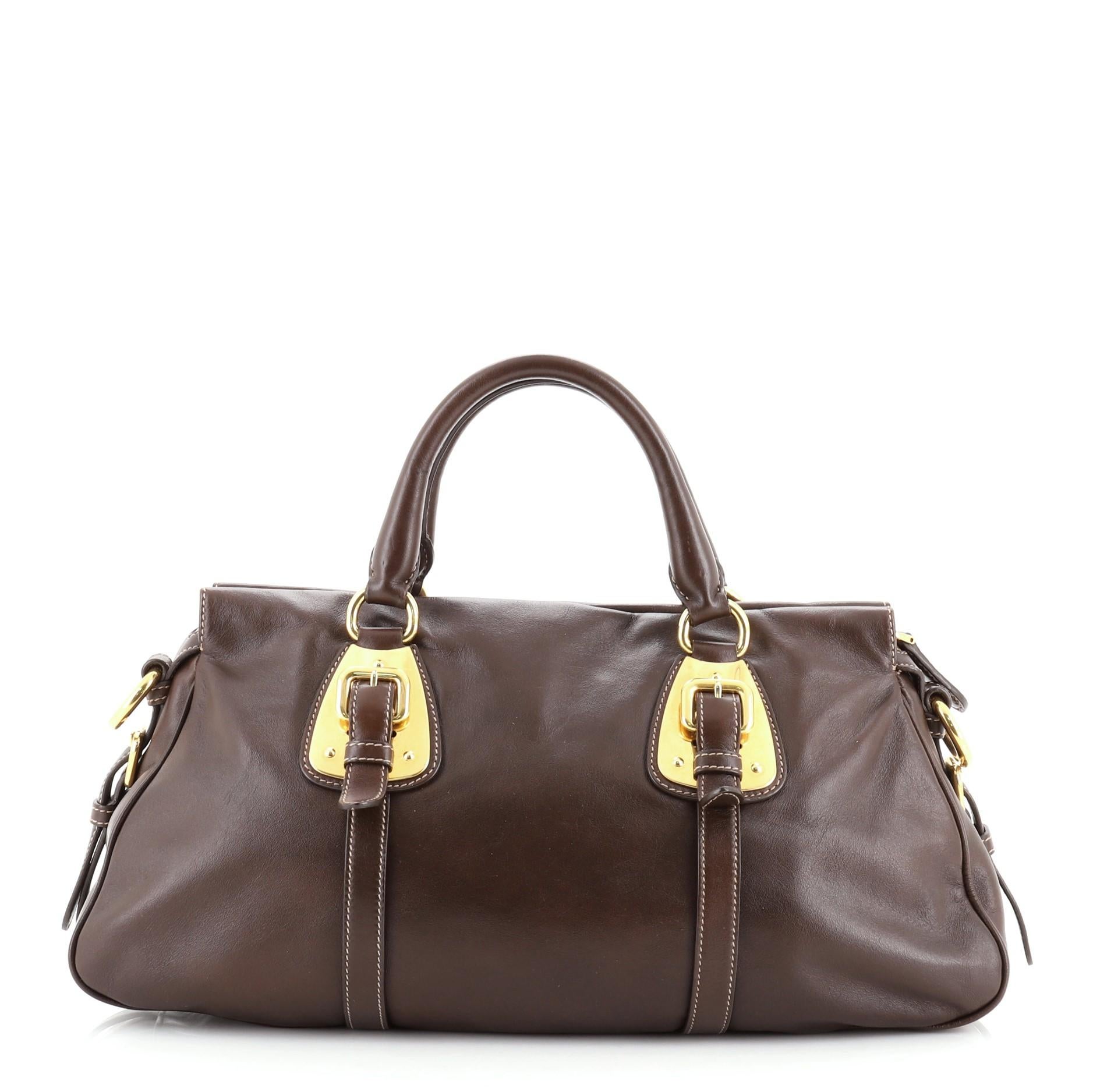 Prada Convertible Belted Satchel Soft Calf Medium
Brown

Condition Details: Creasing, wear and scuffs on exterior, handles and interior opening trim, small indentations on handle bases. Scratches, discoloration and slight tarnish on