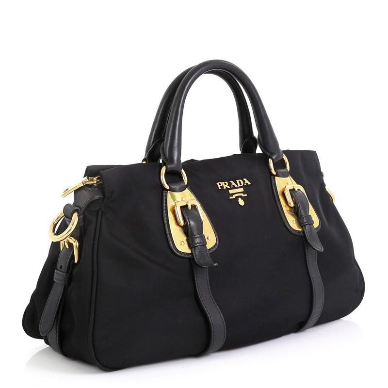 This Prada Convertible Belted Satchel Tessuto with Leather Large, crafted from black tessuto with leather, features dual rolled handles, belted details and gold-tone hardware. Its zip closure opens to a black fabric interior. 

Estimated Retail