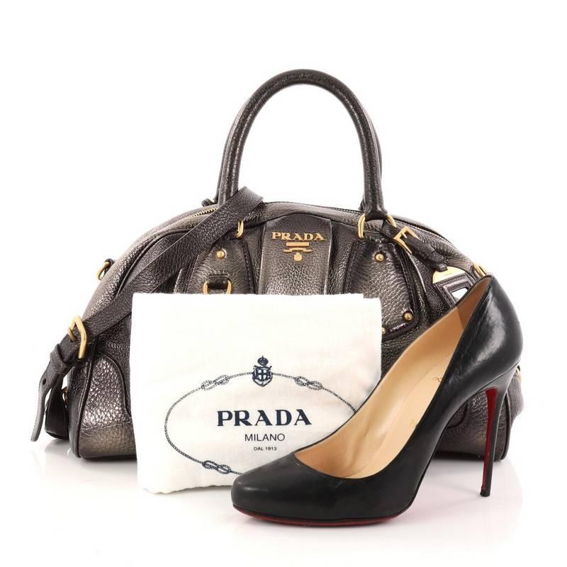 This authentic Prada Convertible Bowling Bag Cervo Antik Leather Medium is a beautifully crafted bag perfect for everyday use. Constructed in metalic gold cervo antik leather, this bag features dual-rolled handles, stud detailing, trademark Prada